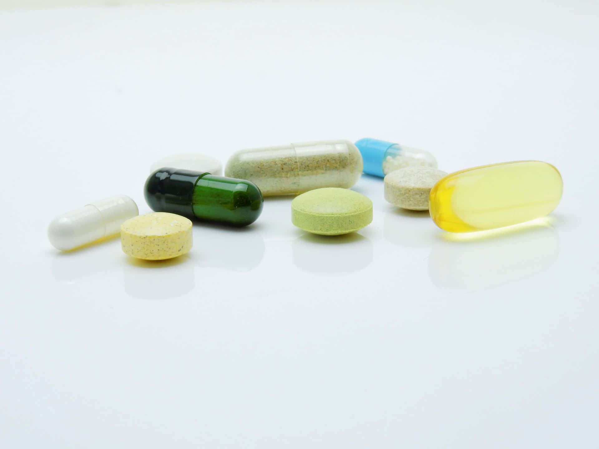 Various Pills And Capsules On A White Background
