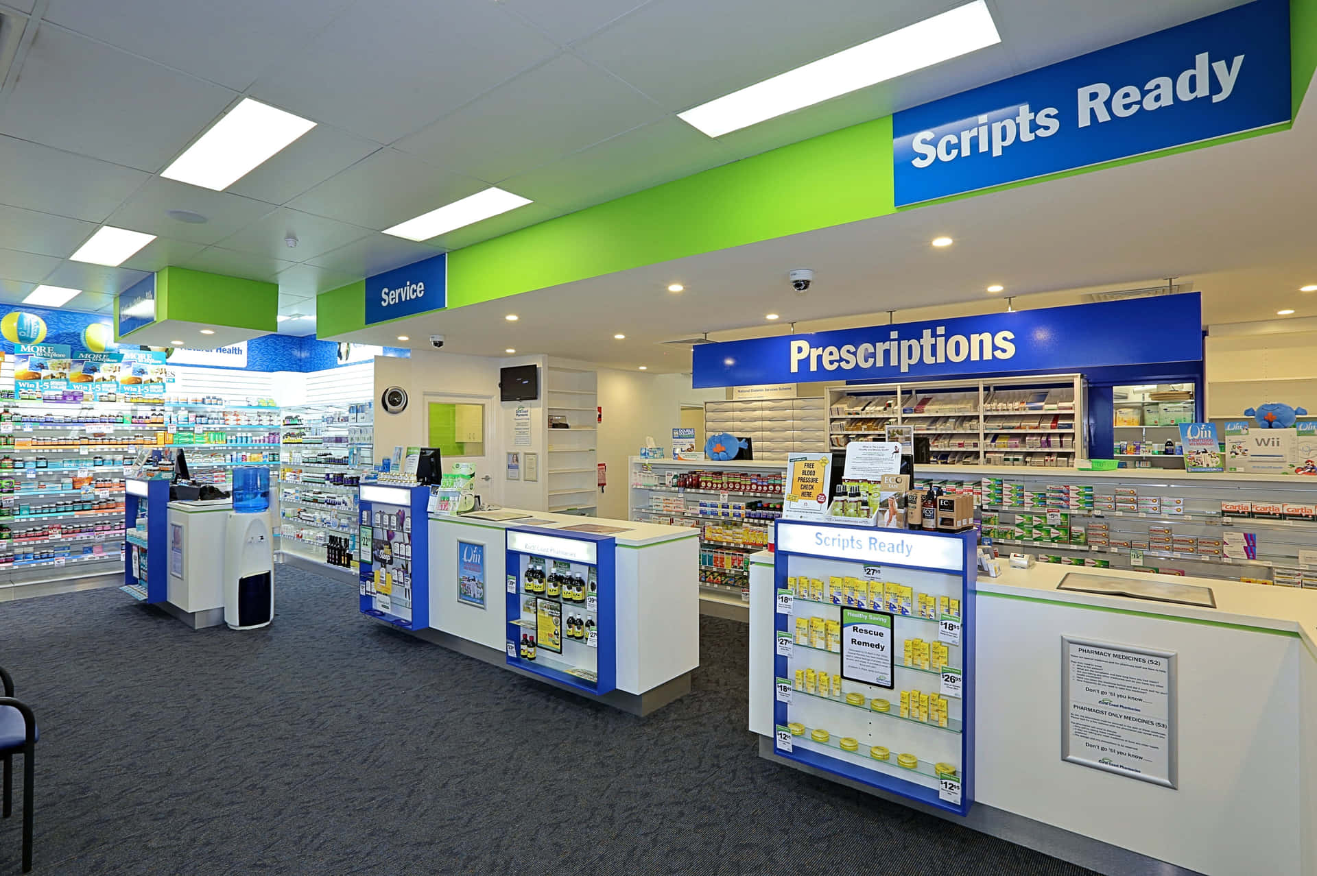 A Pharmacy With A Blue And Green Wall