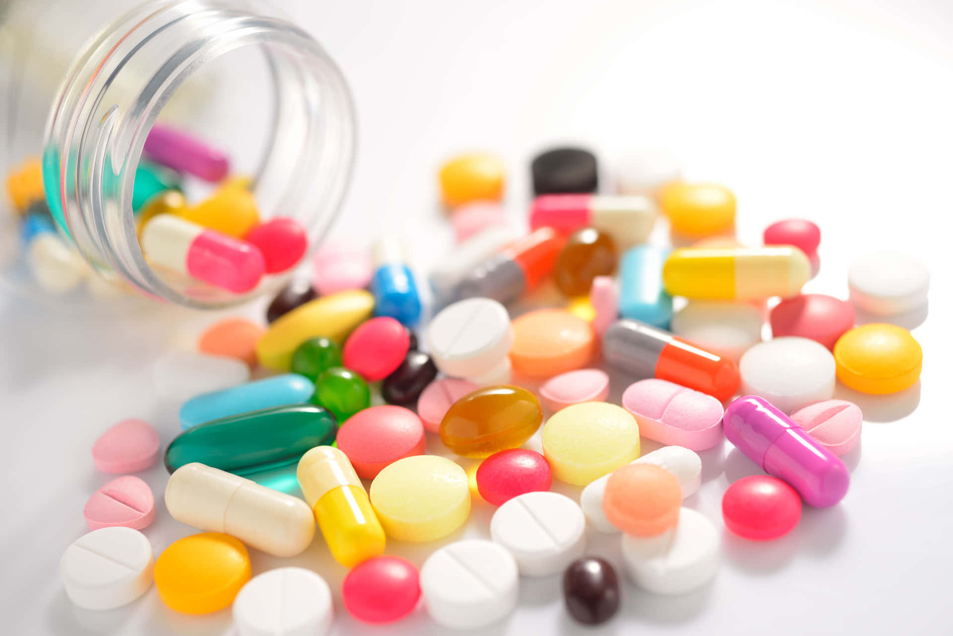 A Jar Of Pills And Tablets Spilling Out