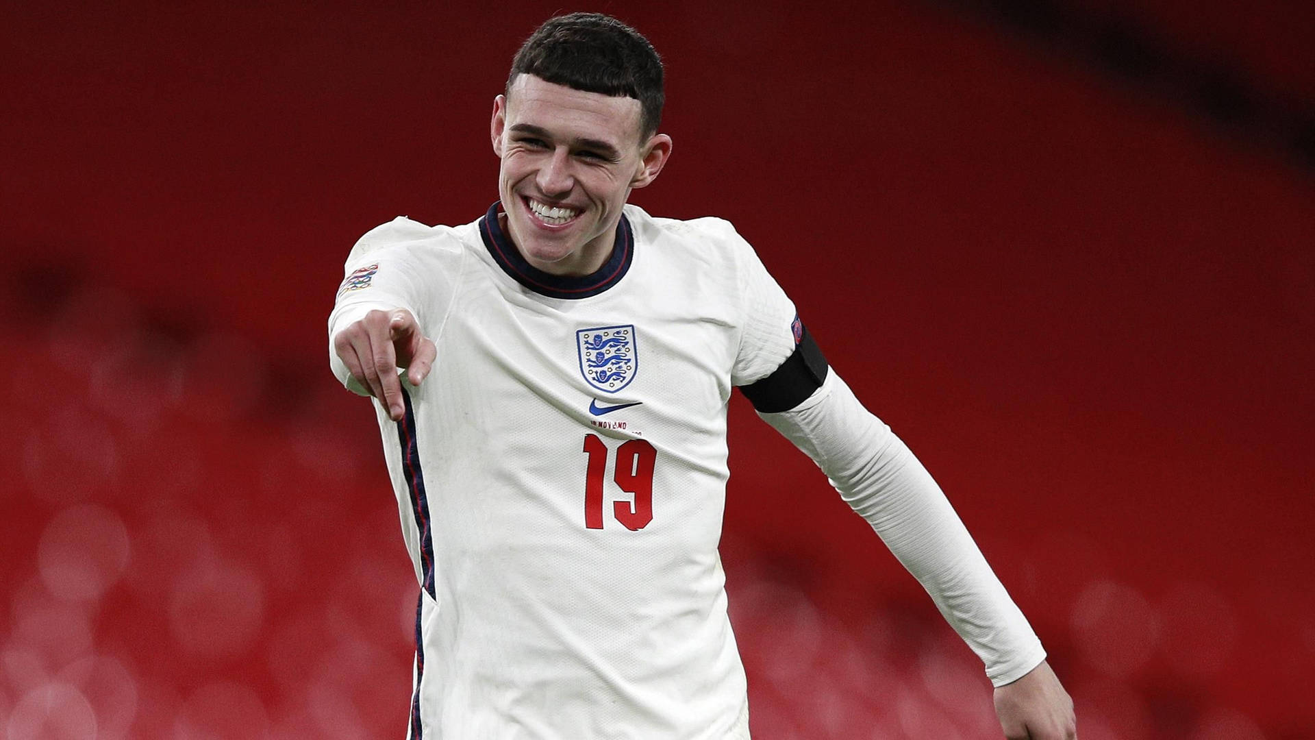 Phil Foden Smiling And Pointing Wallpaper