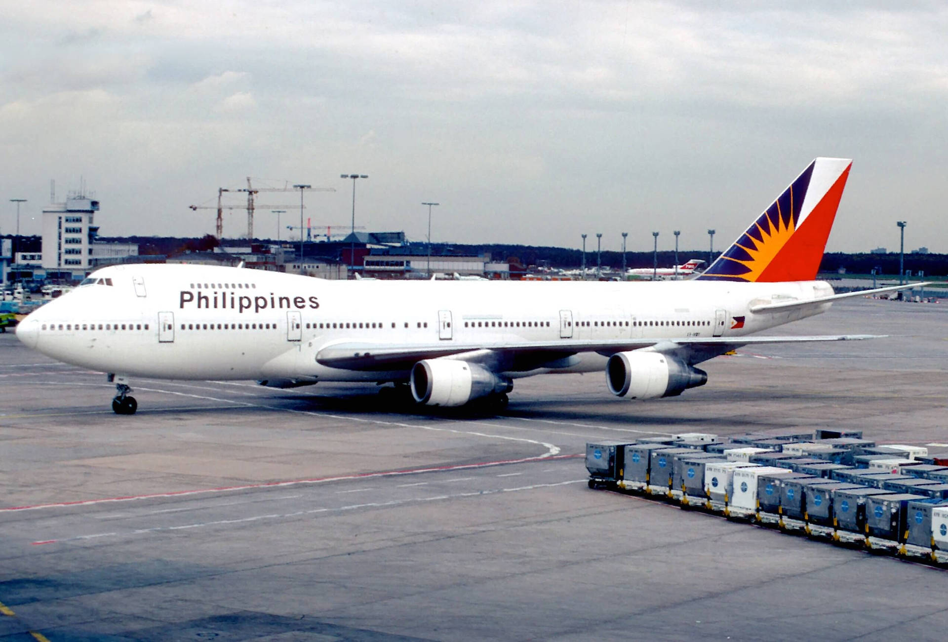 Philippine Airlines On Airport Runway With Cargo Wallpaper