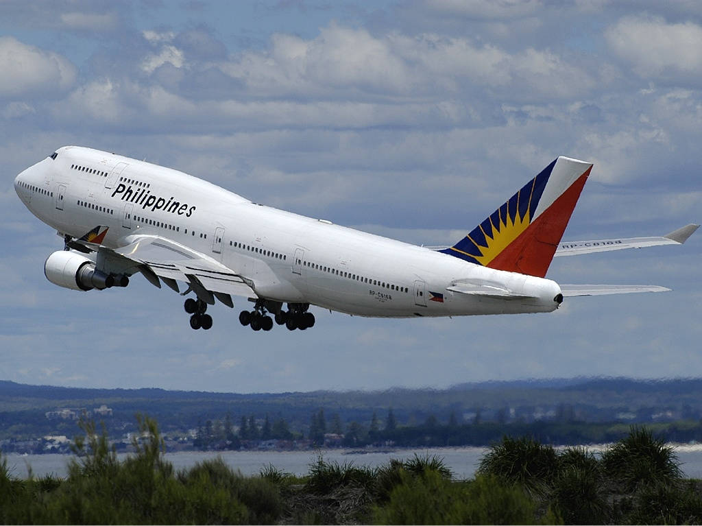 Philippine Airlines Plane Flying Above Trees Wallpaper