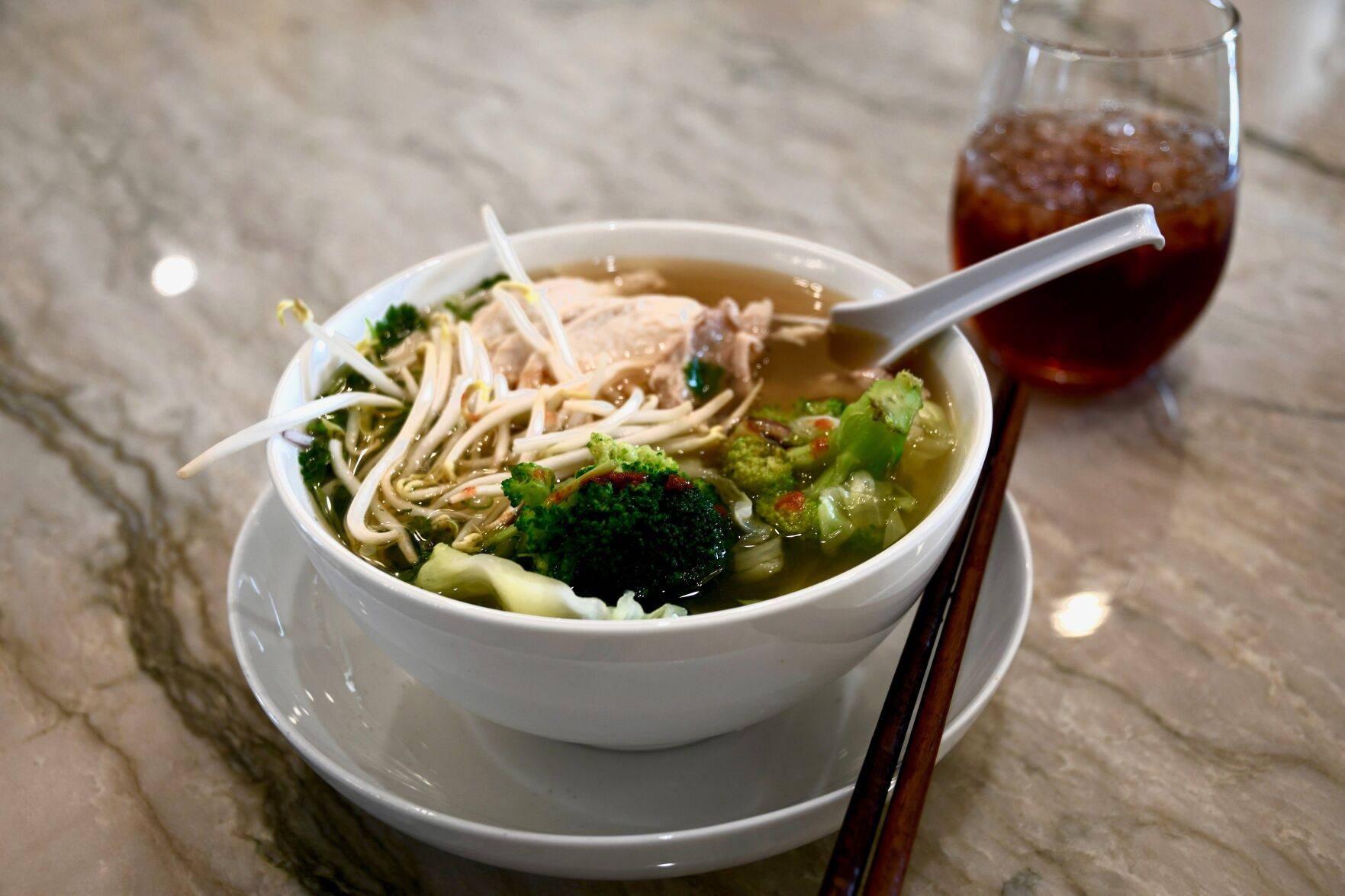 Caption: Delicious Pho Noodle Soup with Fresh Vegetables Wallpaper