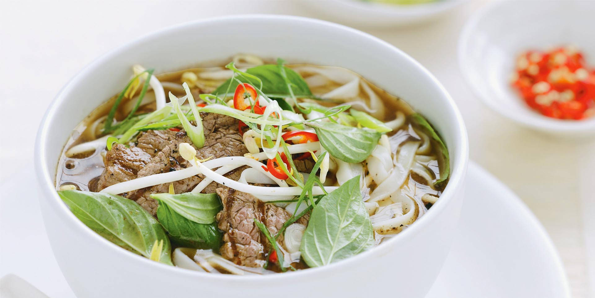 Caption: A tempting bowl of traditional Vietnamese Pho. Wallpaper