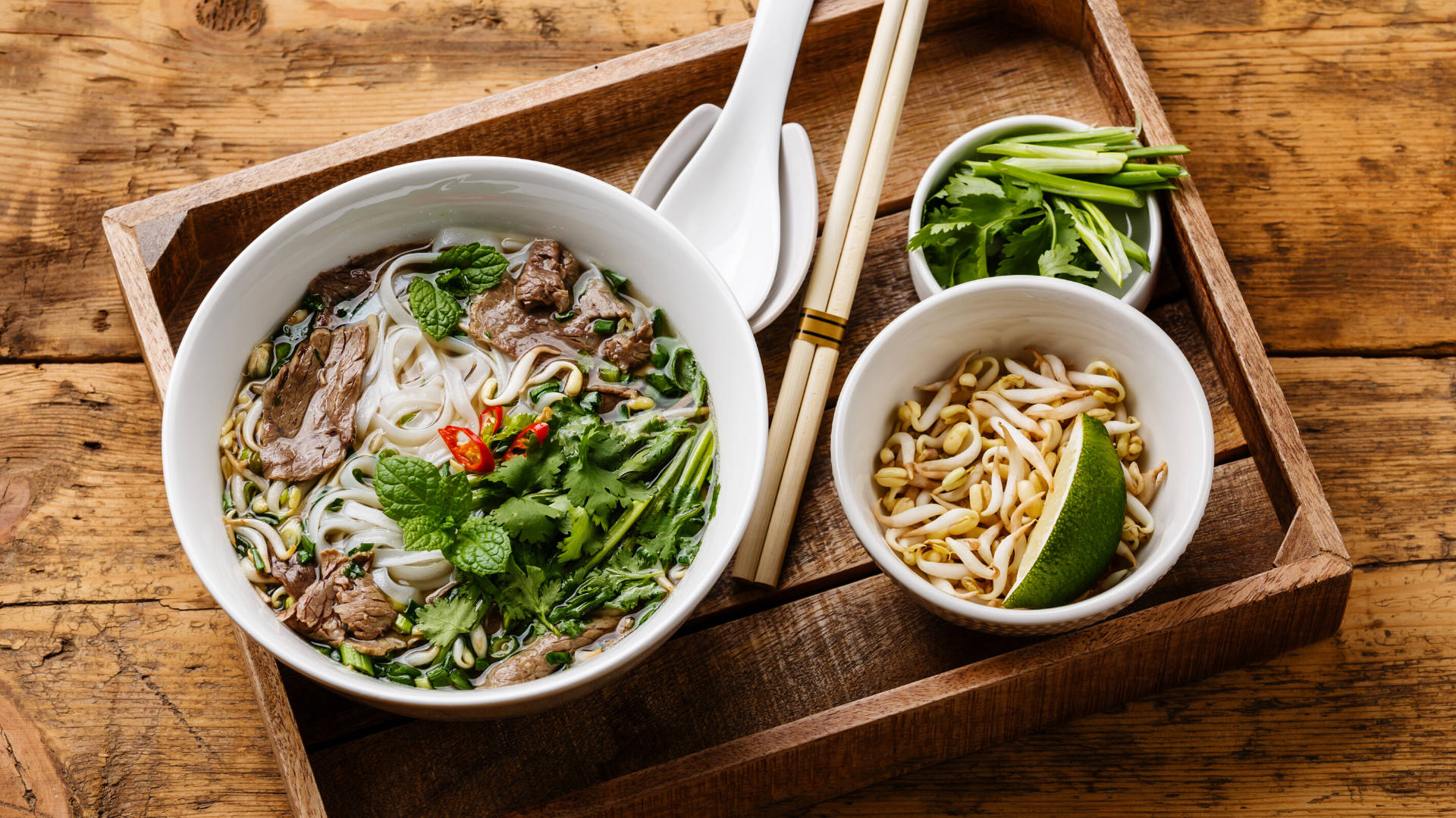 Indulgent bowl of traditional Vietnamese Pho with vegetables and beef Wallpaper