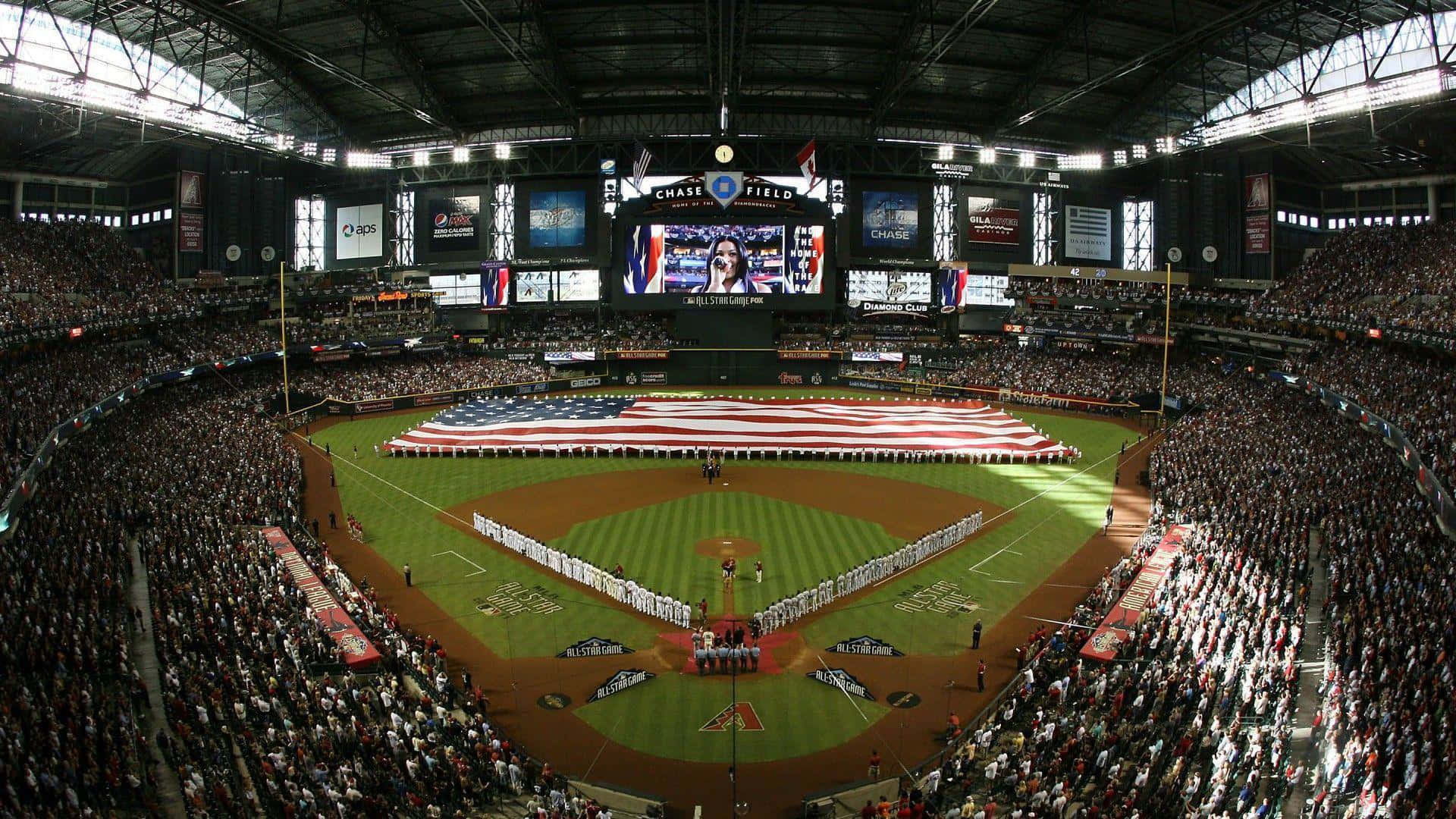 A Baseball Stadium With An American Flag On The Field Wallpaper