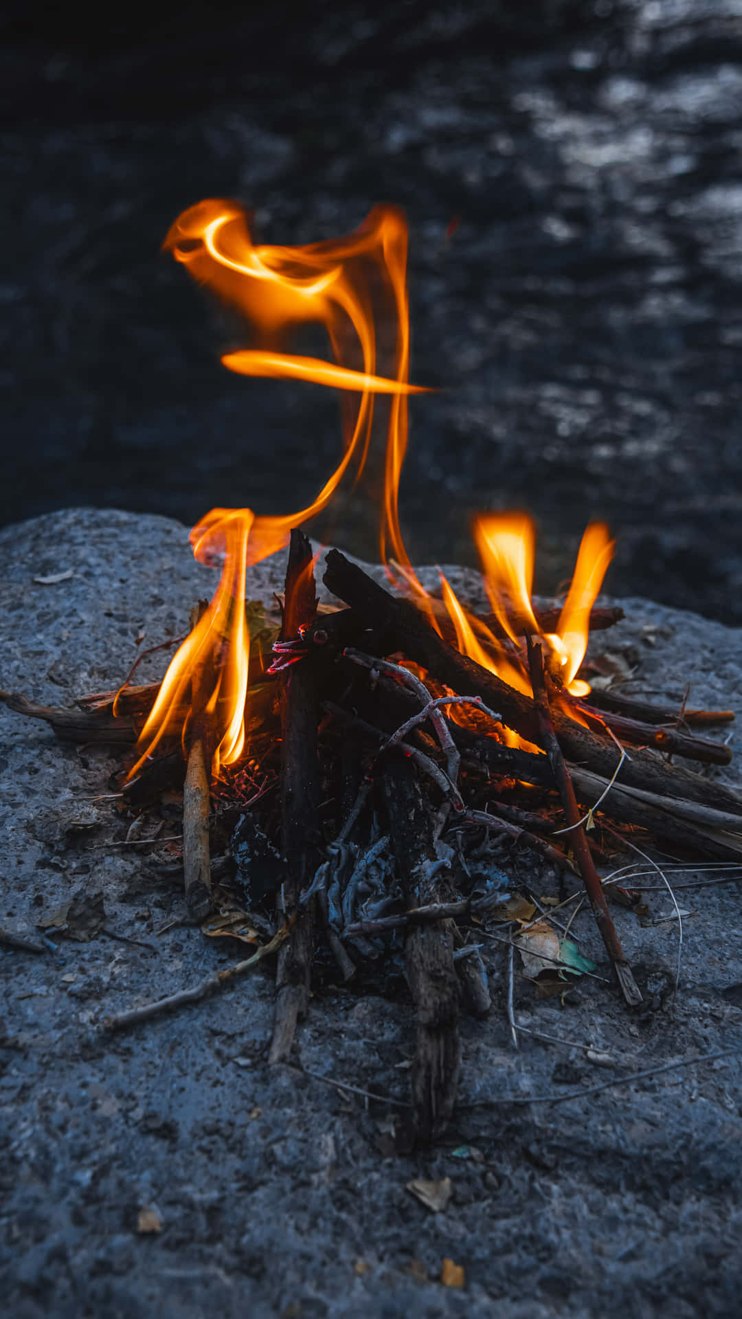 Blazing Campfire On Stone Phone Background