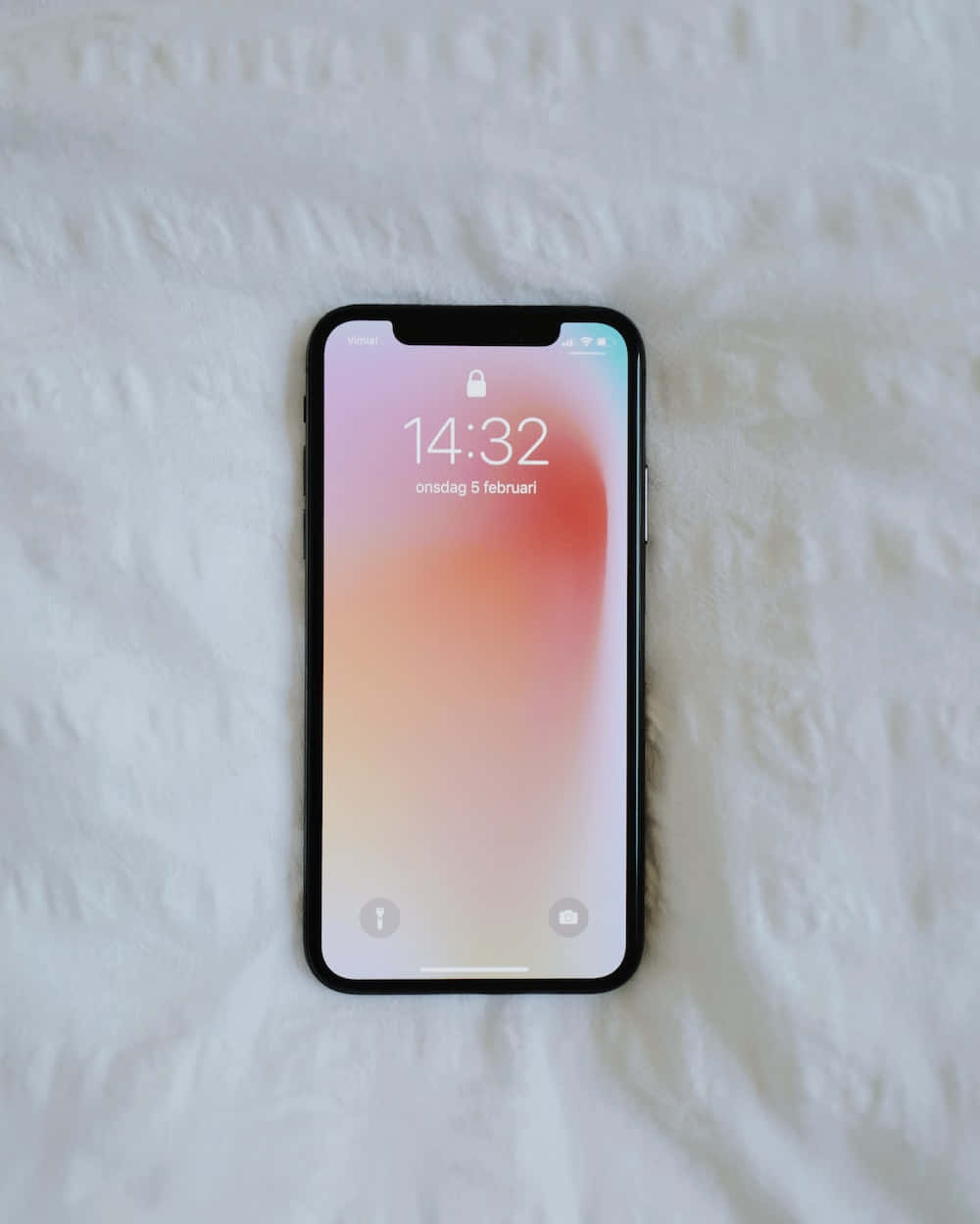 An Iphone X Is Laying On A Bed