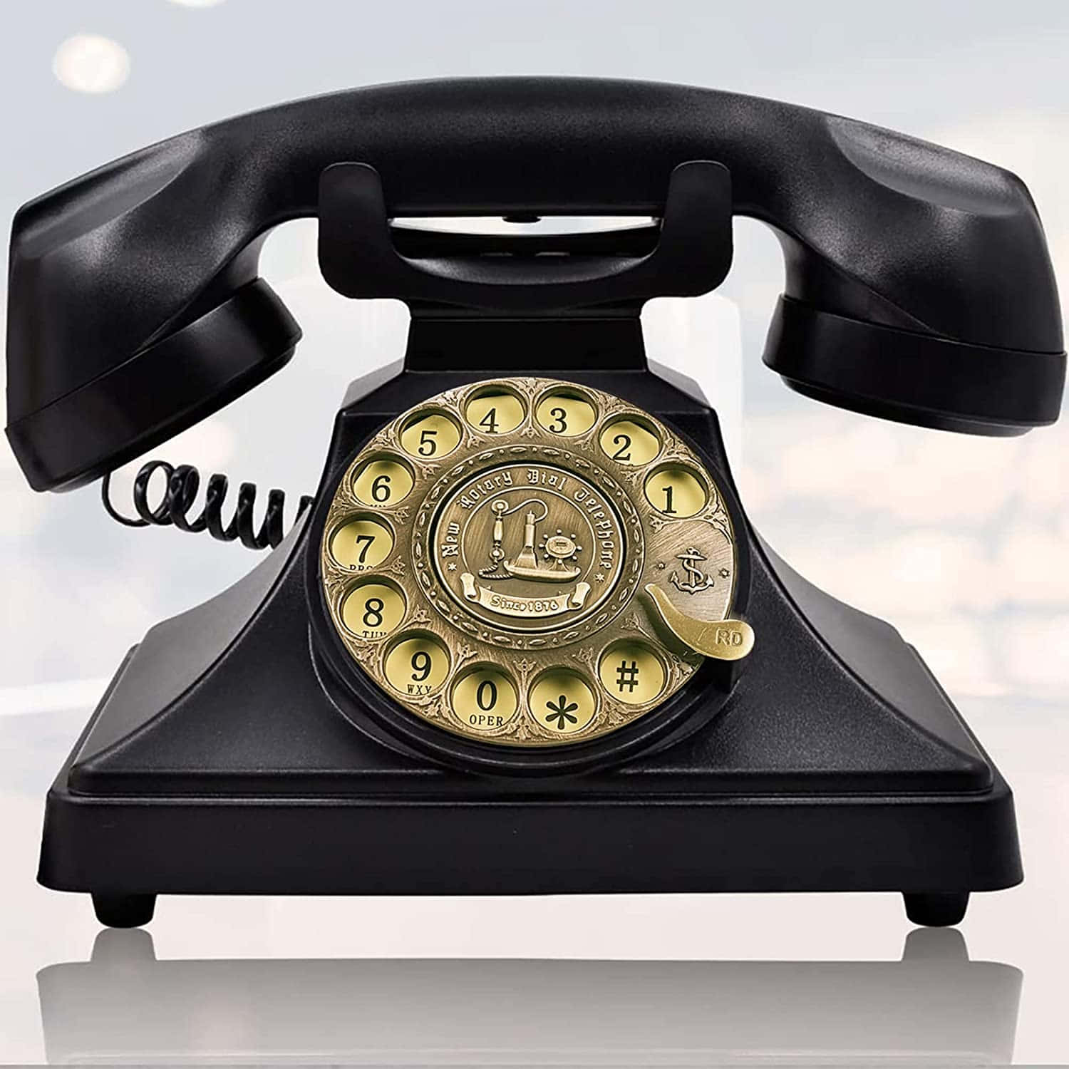 A Black Telephone With A Gold Dial
