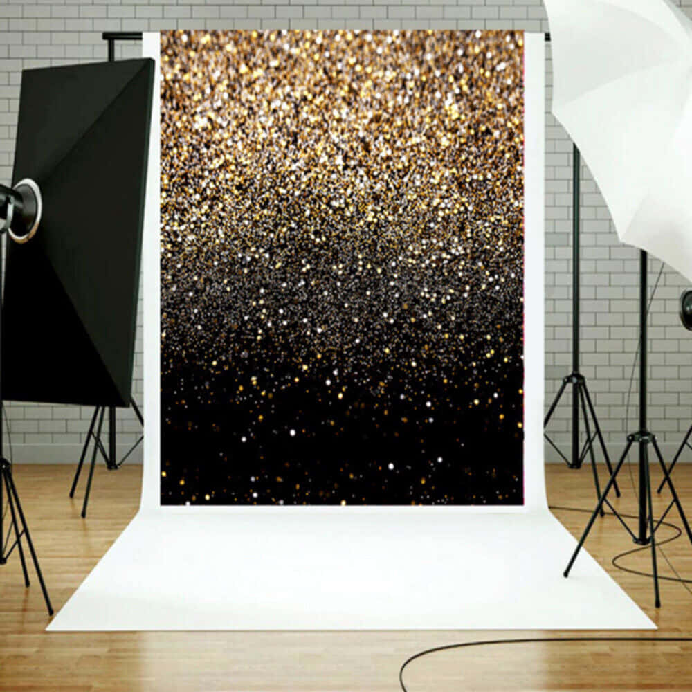 A Black And Gold Glitter Backdrop With Lights