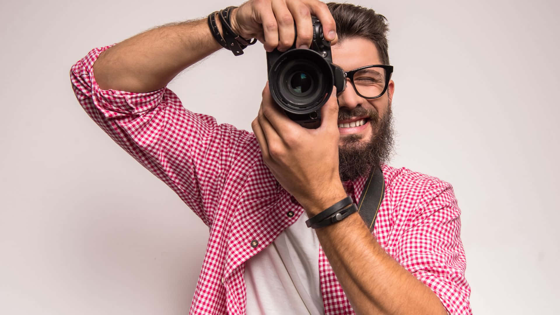 A Man With A Beard And Glasses Taking A Picture With His Camera