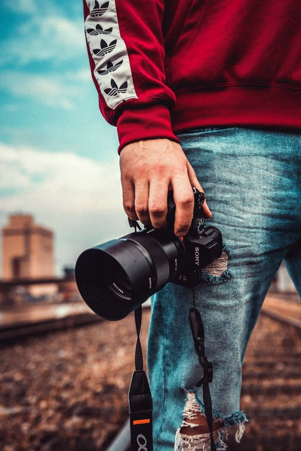 Photographer Holding Camera_ Outdoor Setting Wallpaper
