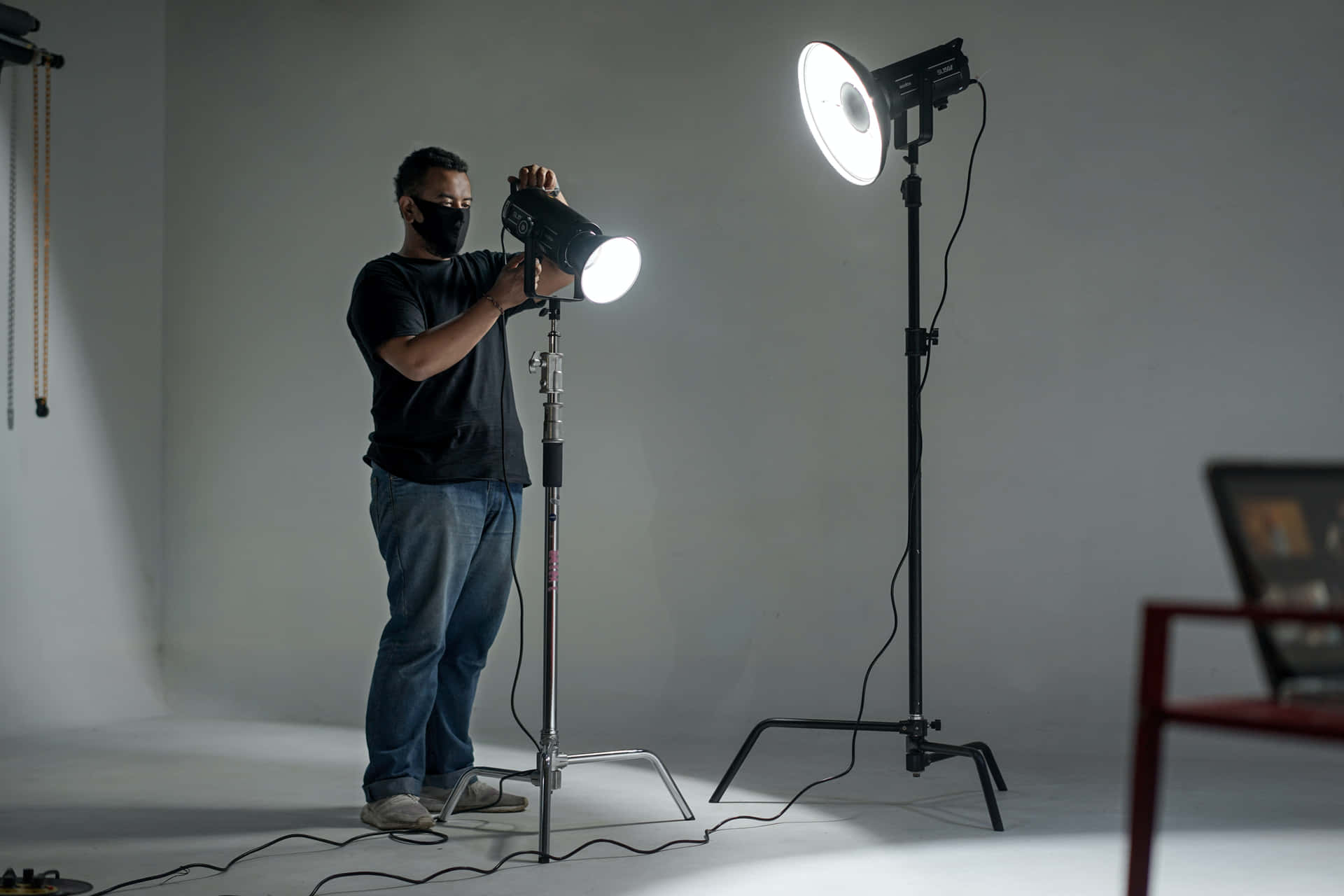 A Man Is Standing In Front Of A Light Stand