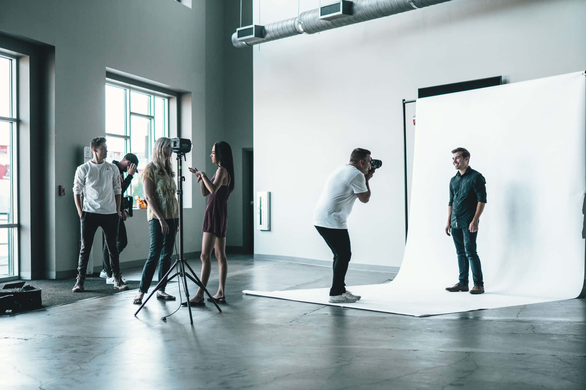 A Group Of People In A Studio Taking Pictures