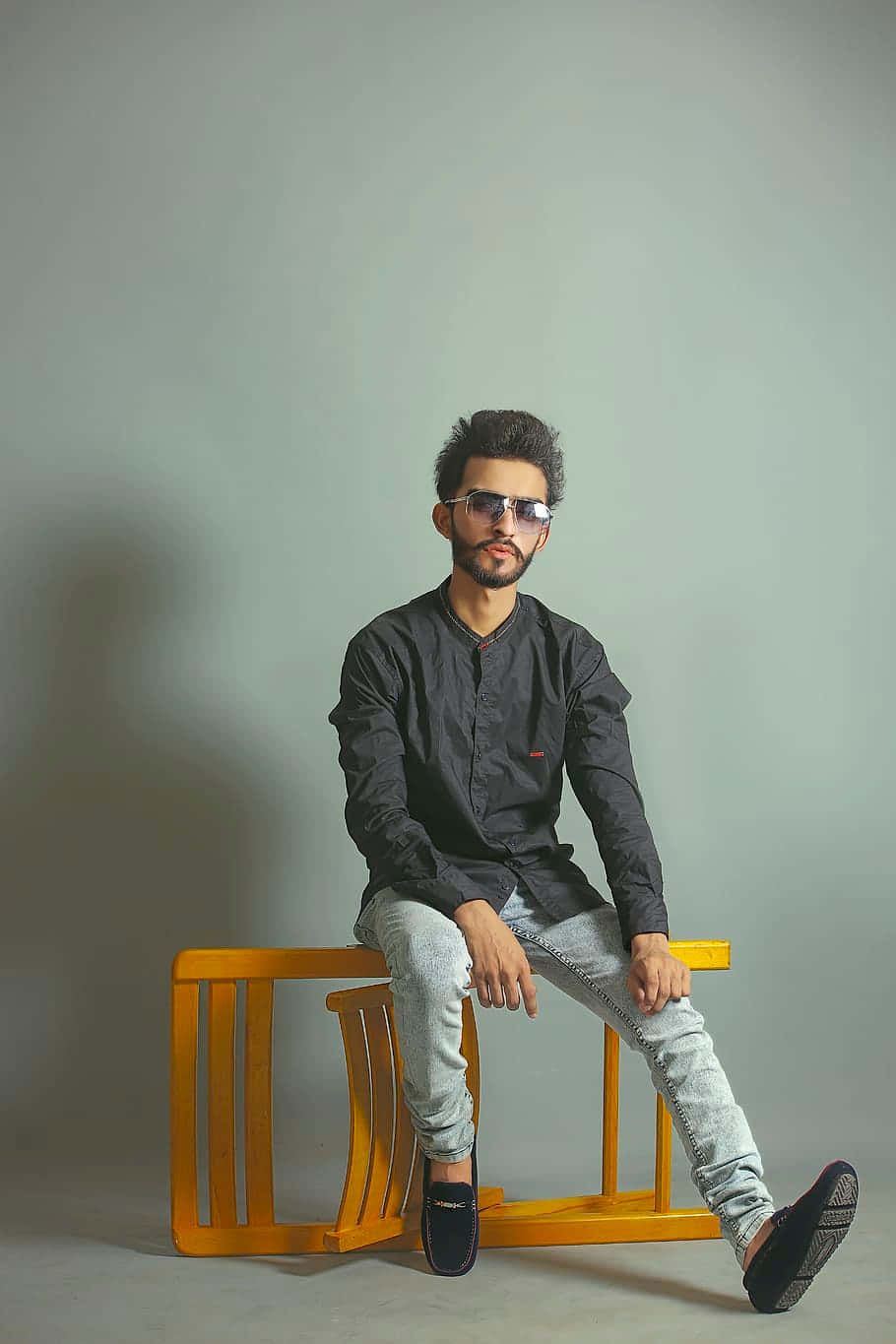 Photoshoot Of A Man Sitting Wallpaper