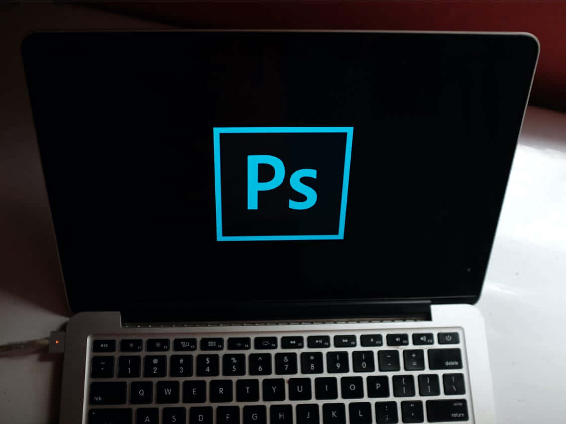 Photoshop Logo On A Laptop Screen Wallpaper