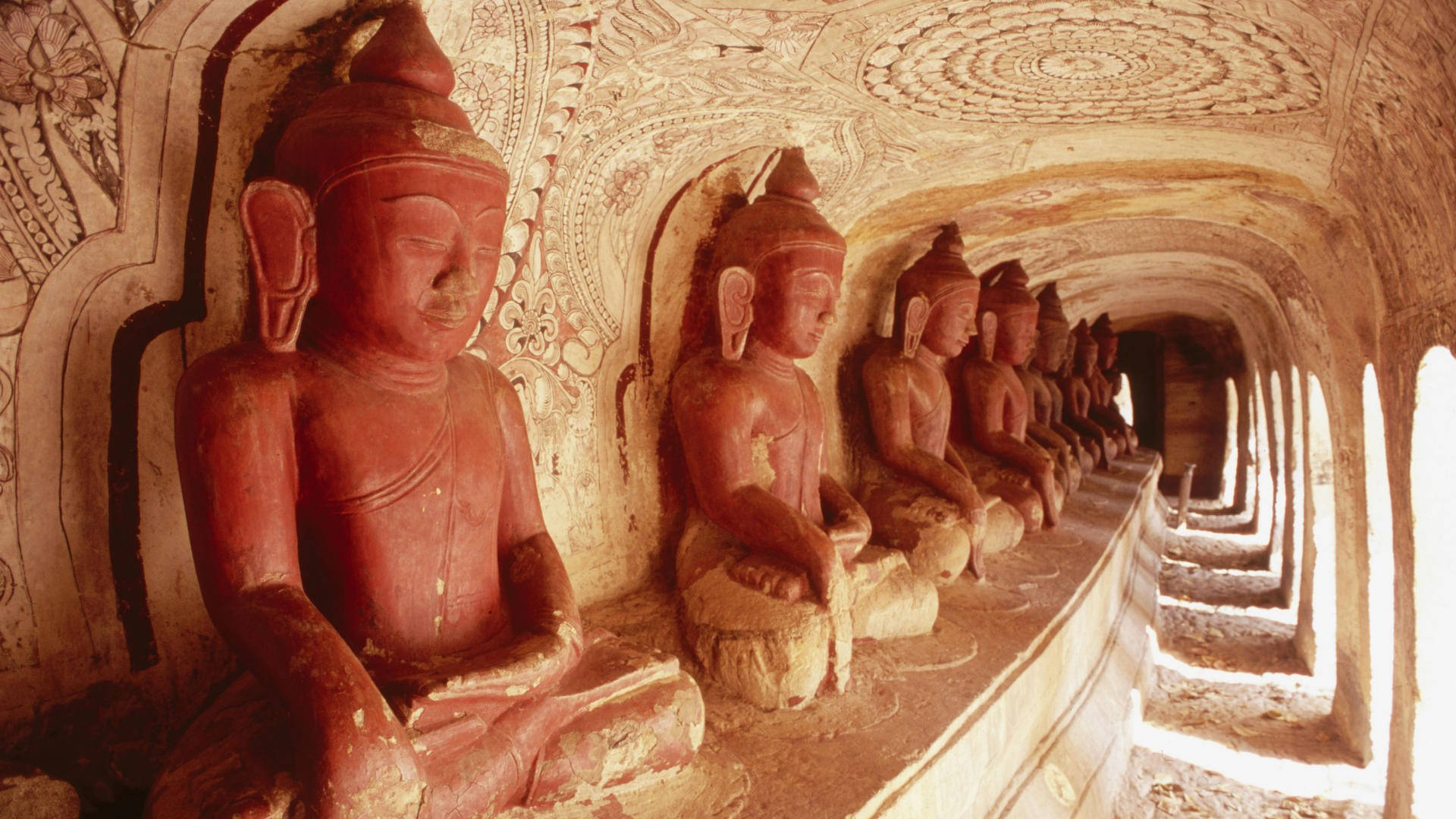 Serene Buddha Statue Amidst Phowintaung Cave Complex Wallpaper