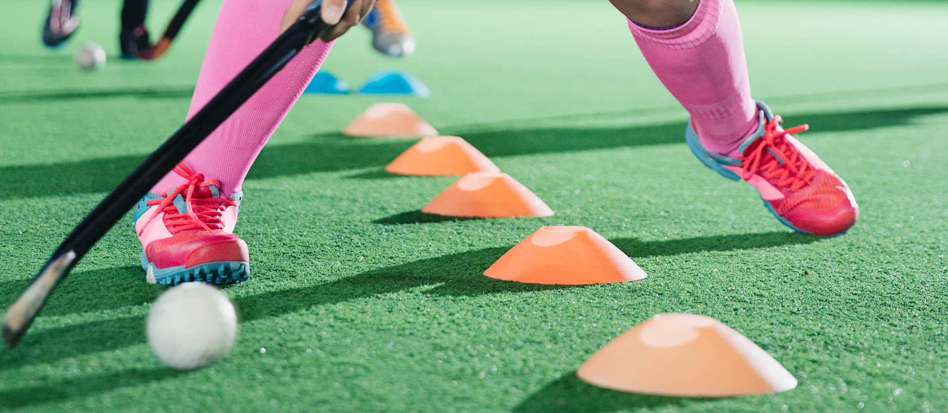 field hockey players playing with cones Wallpaper