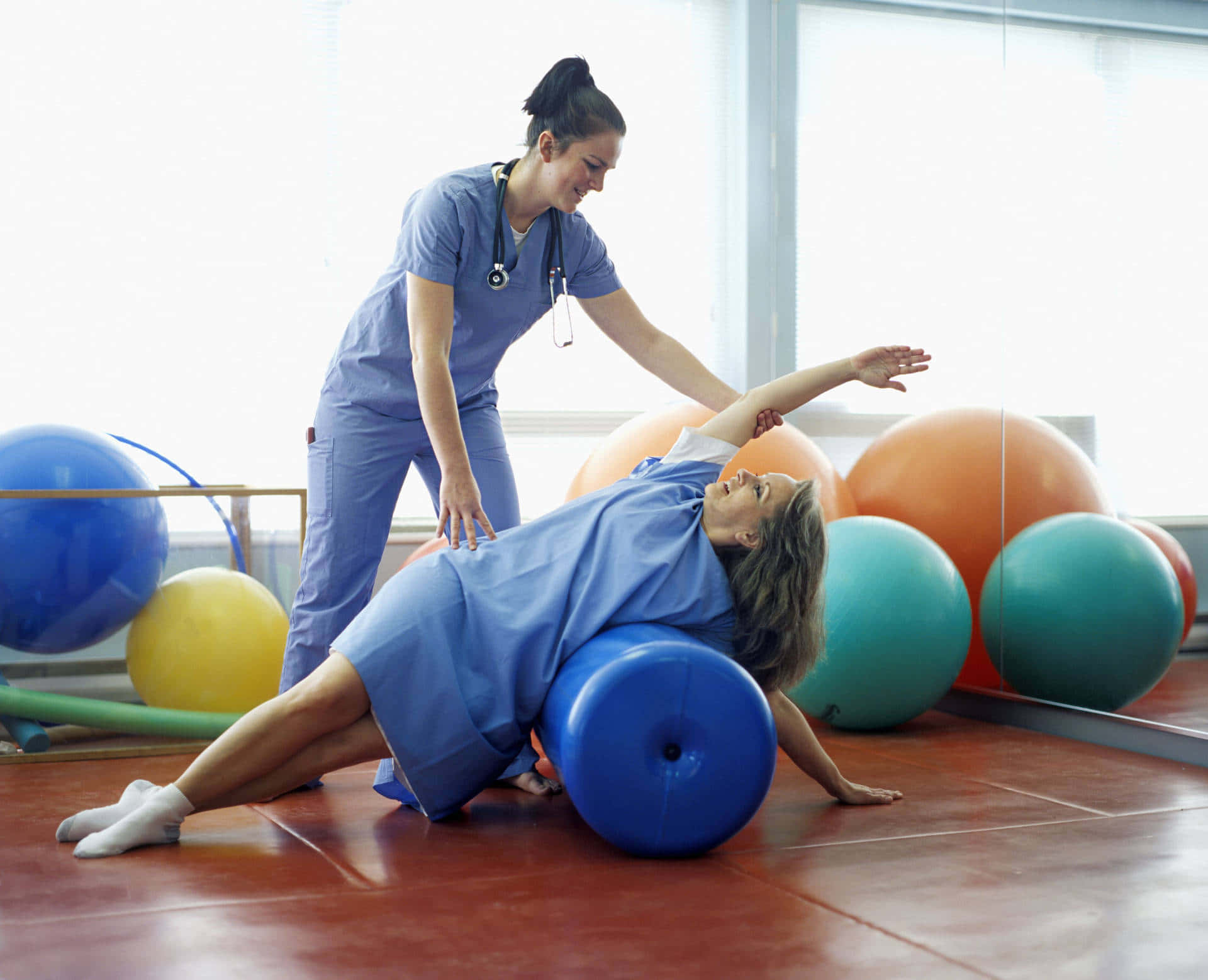 Caption: Young Woman Performing Stretching Exercises in Physical Therapy Wallpaper