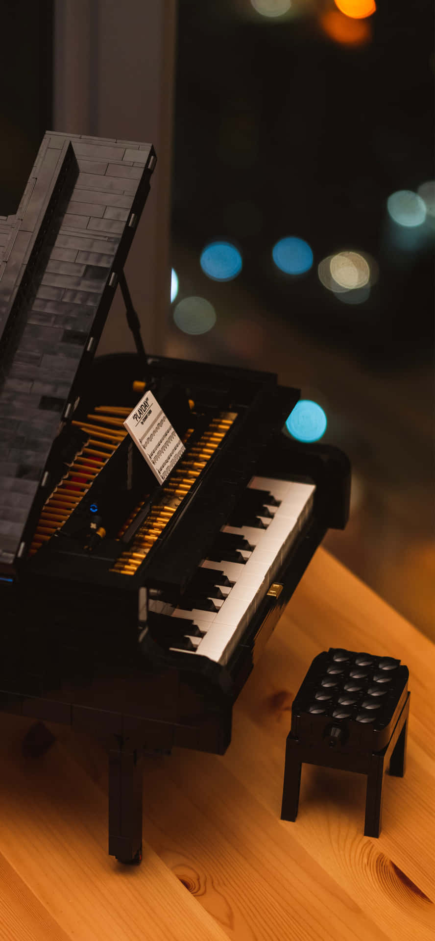 A Lego Piano Sitting On A Table With A Stool