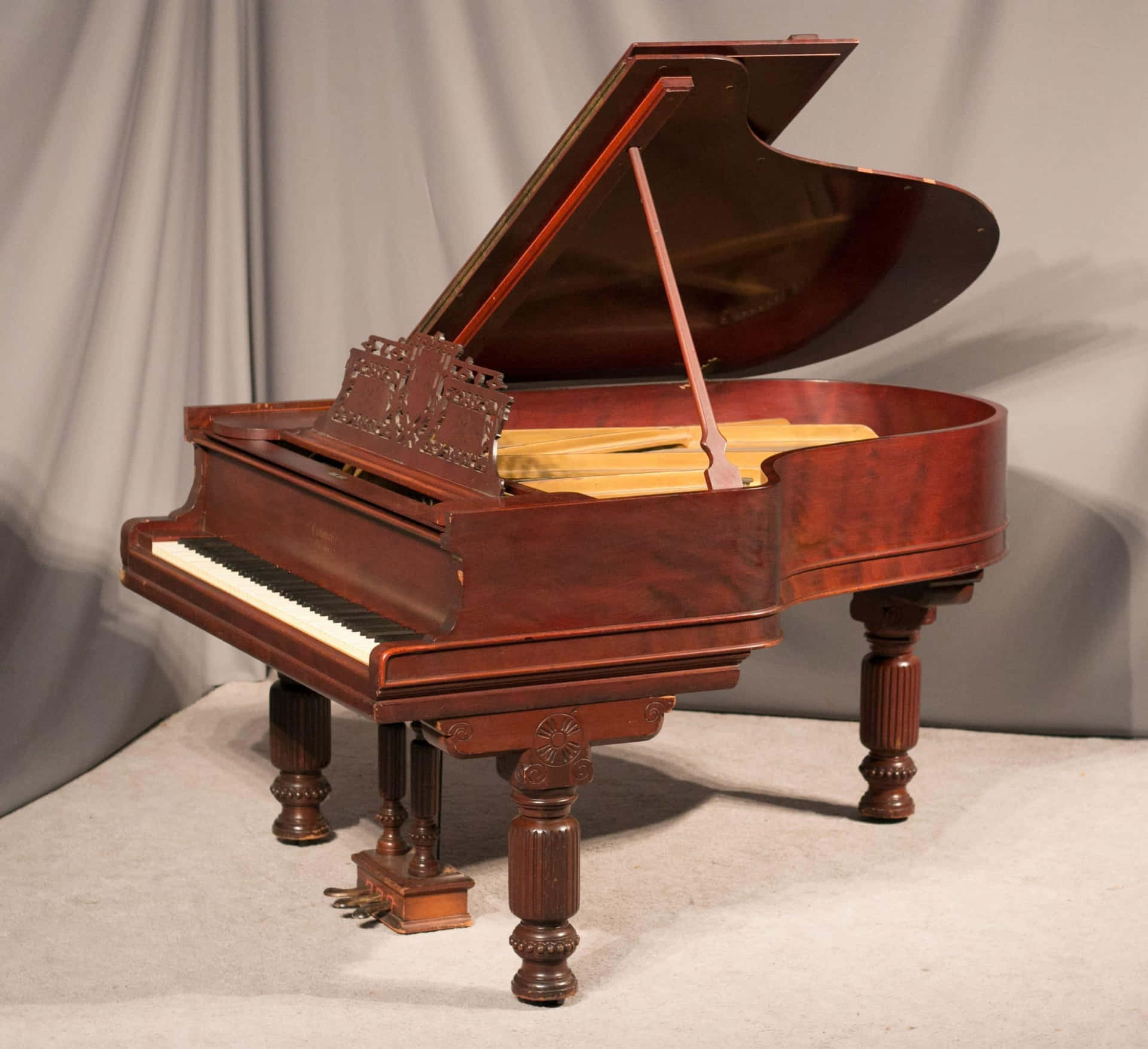 A Grand Piano With A Wooden Frame And A Wooden Top