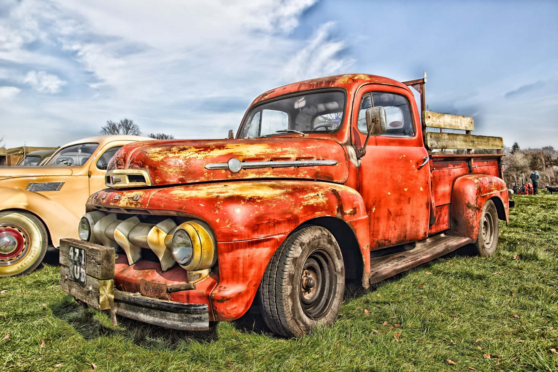 A Red Truck Parked In The Grass