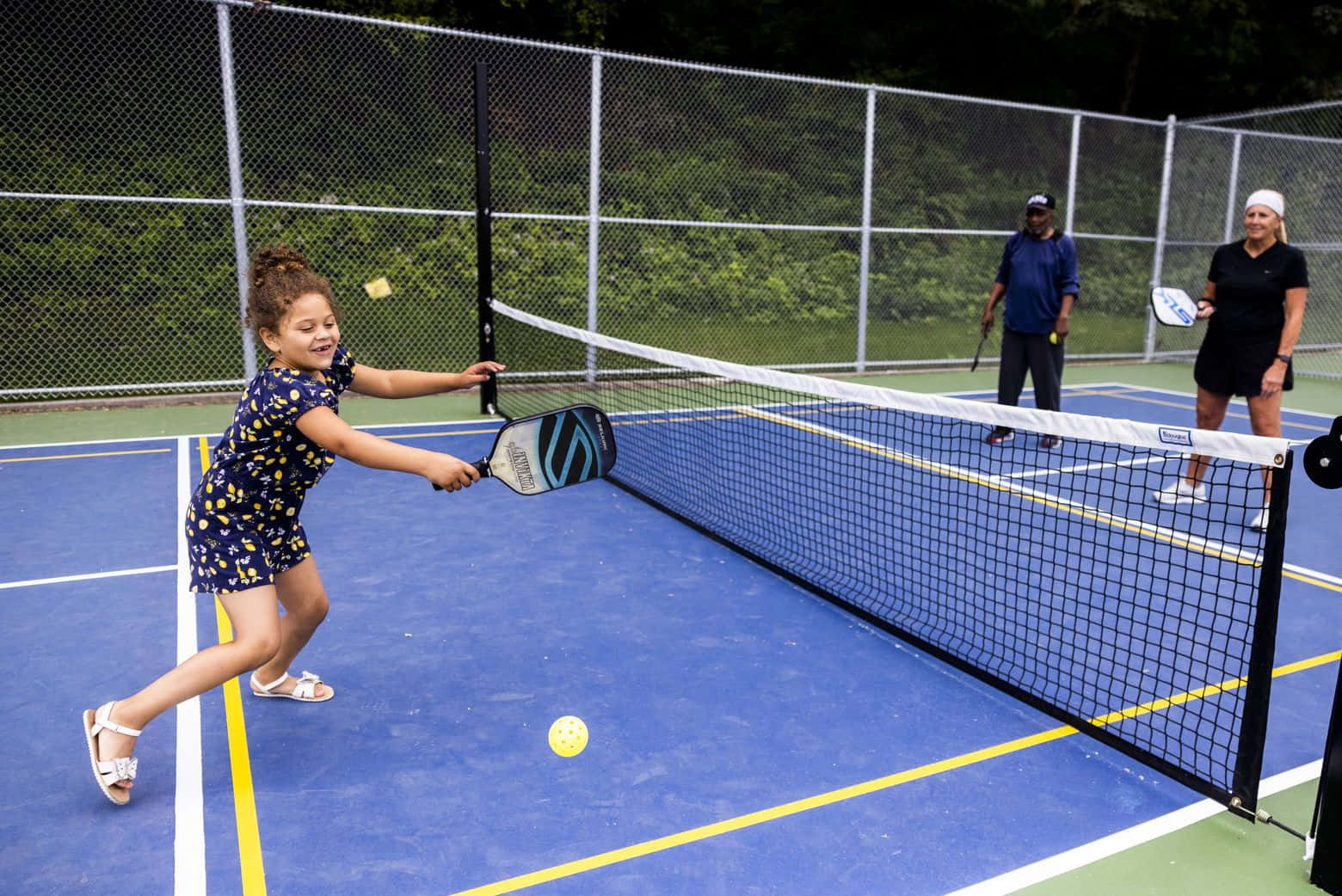 A Girl Is Playing Tennis On A Court