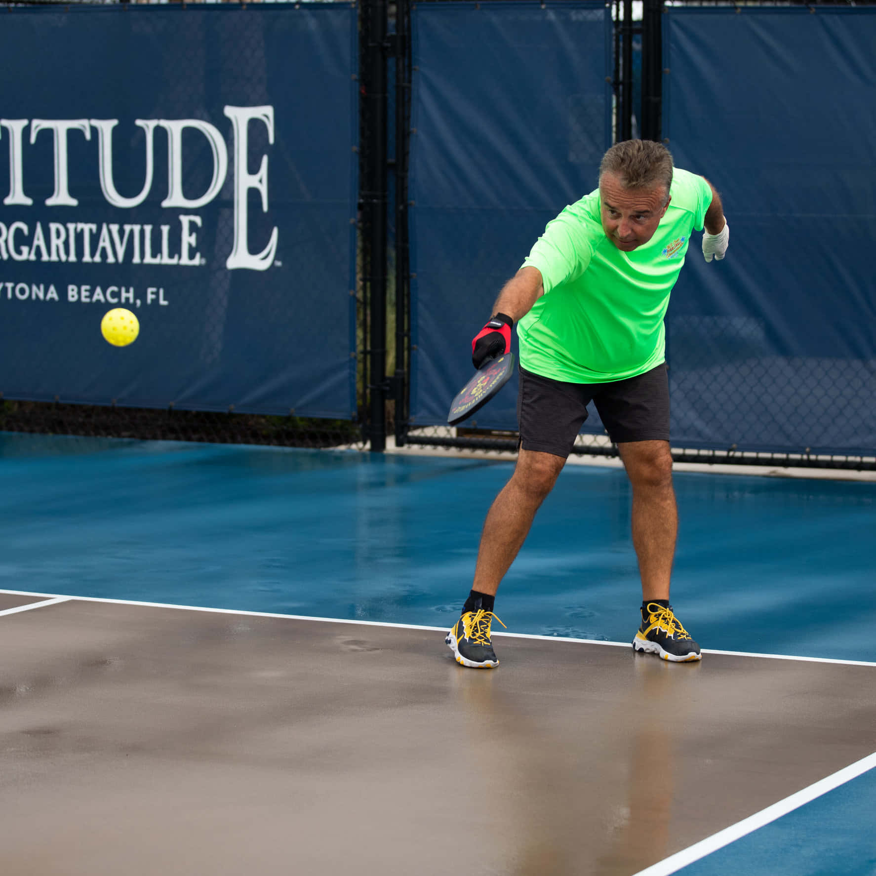 A Man Is Playing Tennis On A Court
