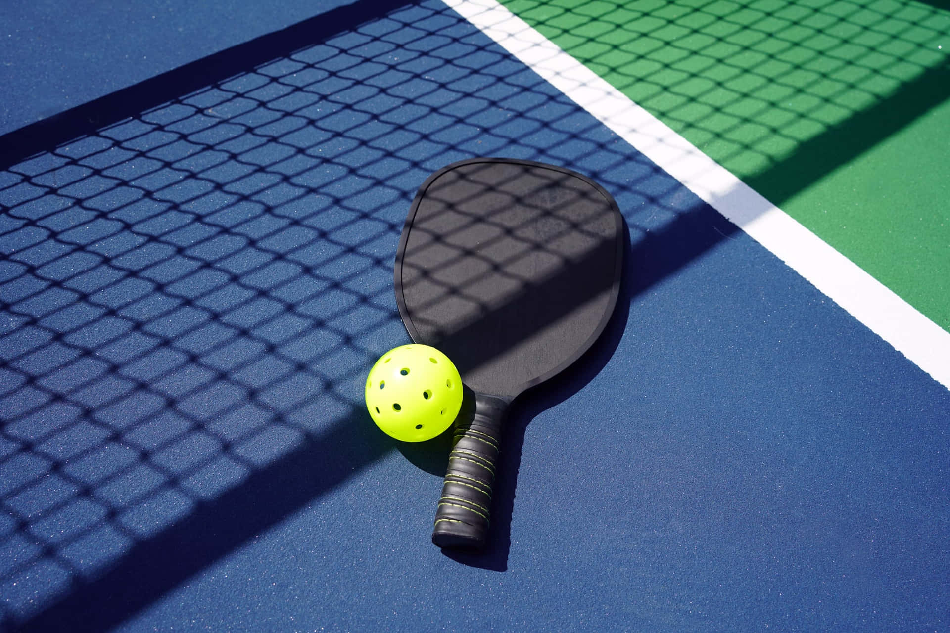 A Tennis Racket And Ball On A Tennis Court