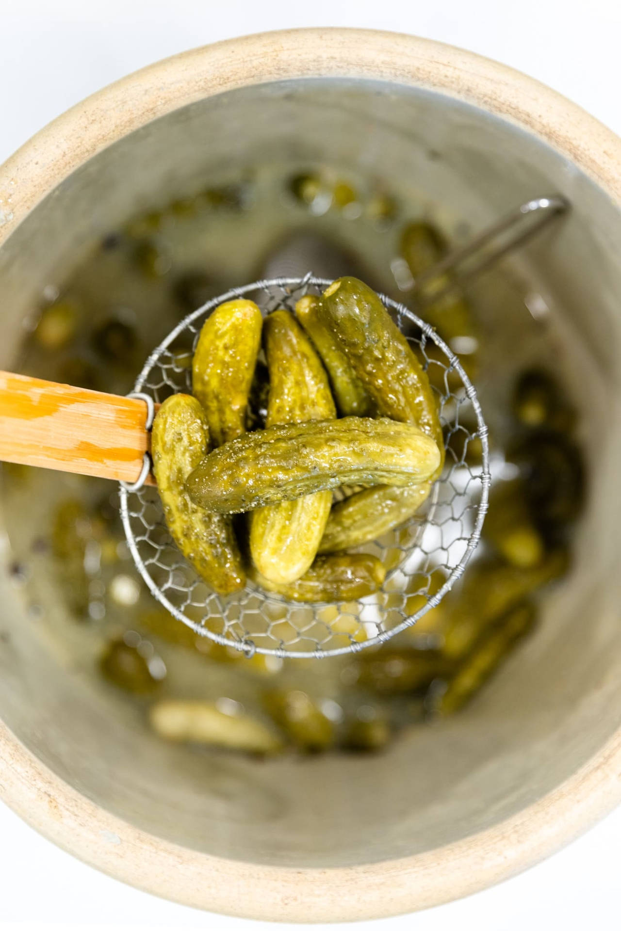 Pickles In A Strainer