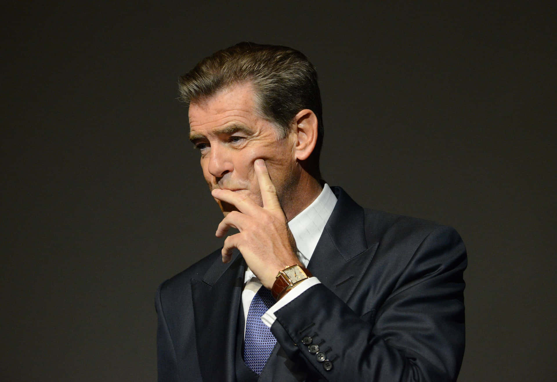 Caption: Iconic Pierce Brosnan in a thoughtful pose Wallpaper