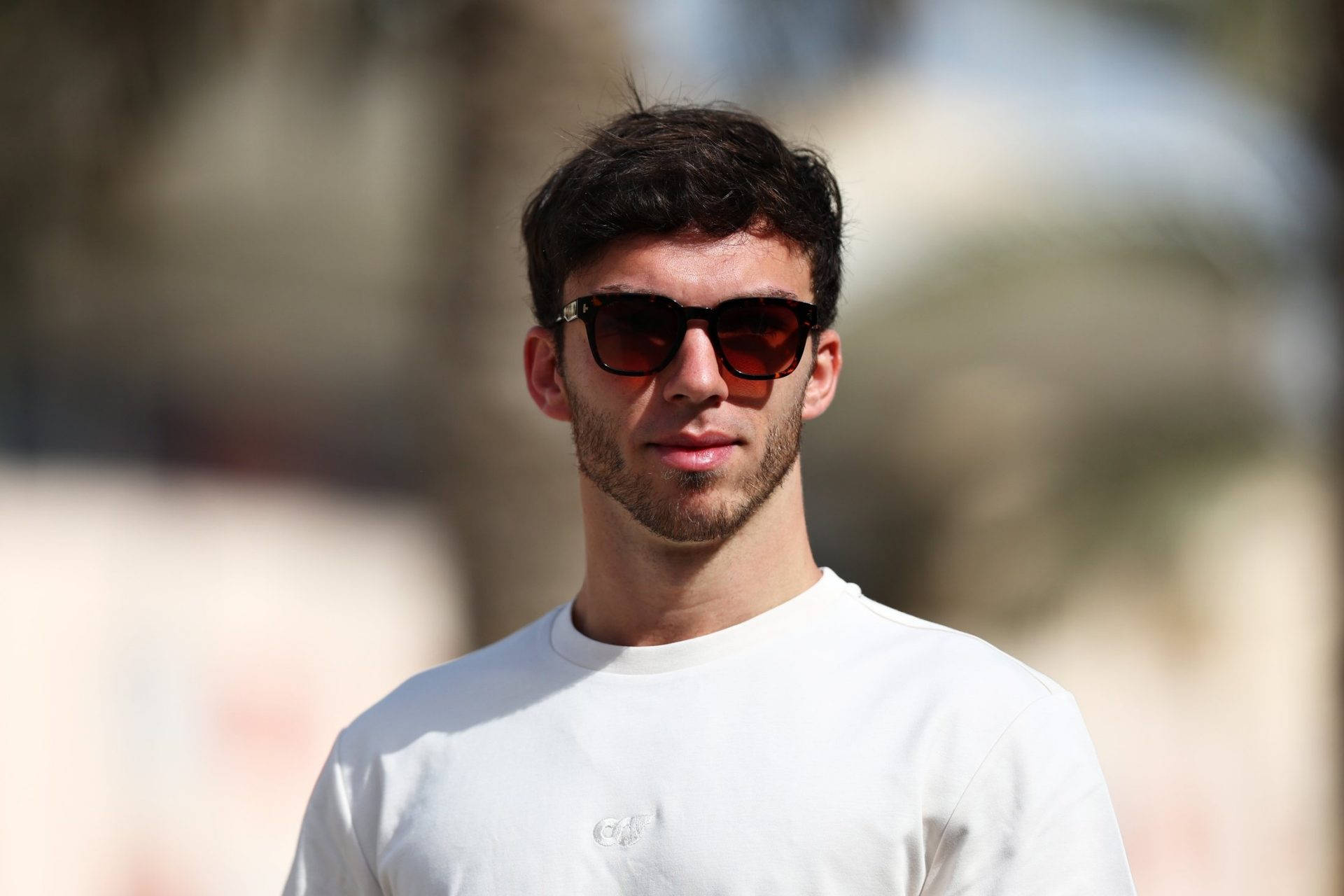 Pierre Gasly exuding confidence in simple white shirt. Wallpaper