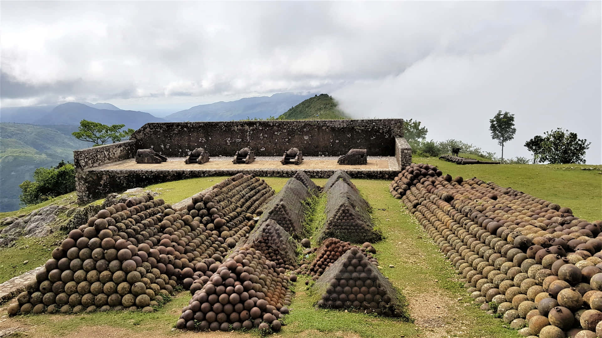 ".Forty two preserved cannonballs stand in a pile at Citadelle Laferriere, Haiti." Wallpaper