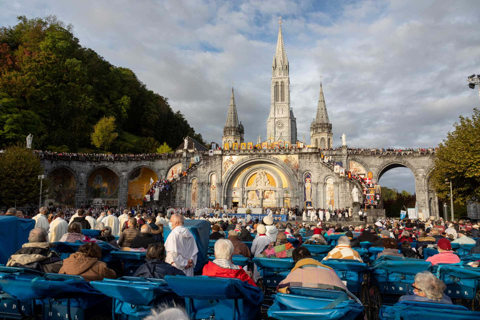 Pilgrims At The Holy Lourdes Grotto Sanctuary In France Wallpaper