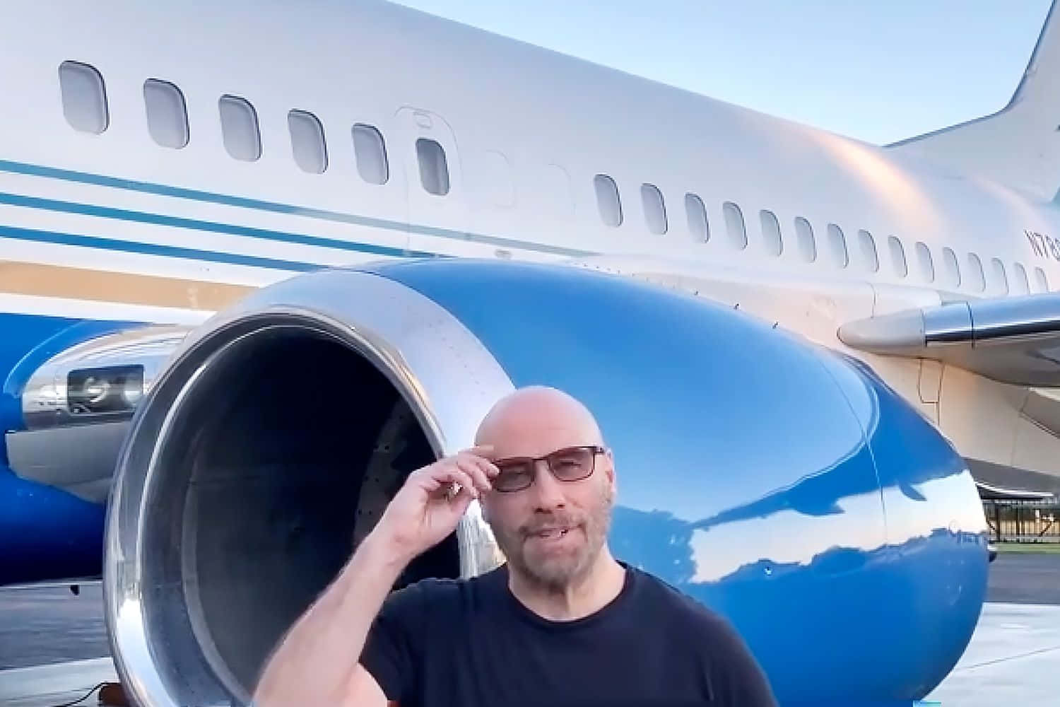 Bald Pilot Standing In Blue Airplane Picture