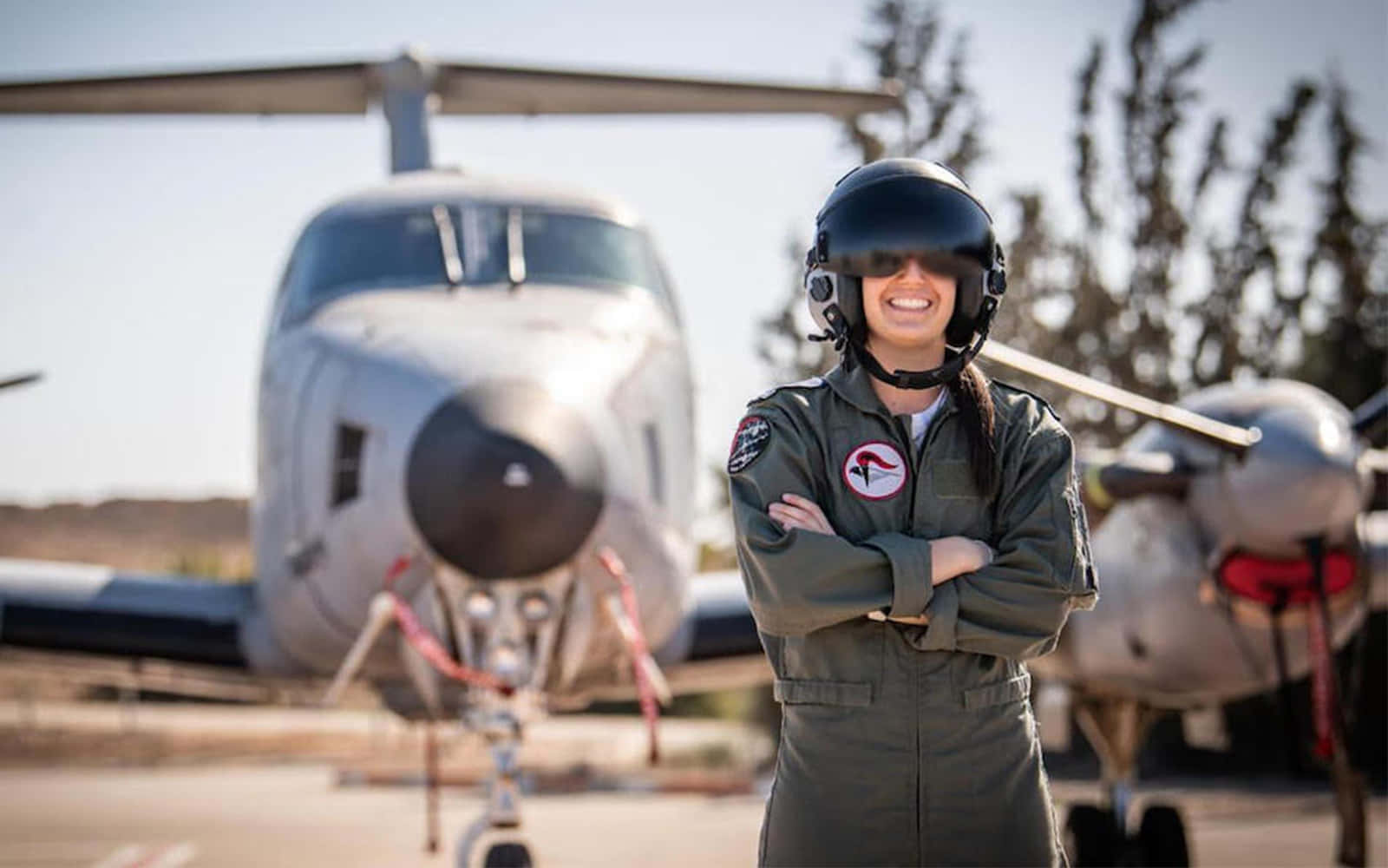 Smiling Woman Pilot Next To Airplane Picture