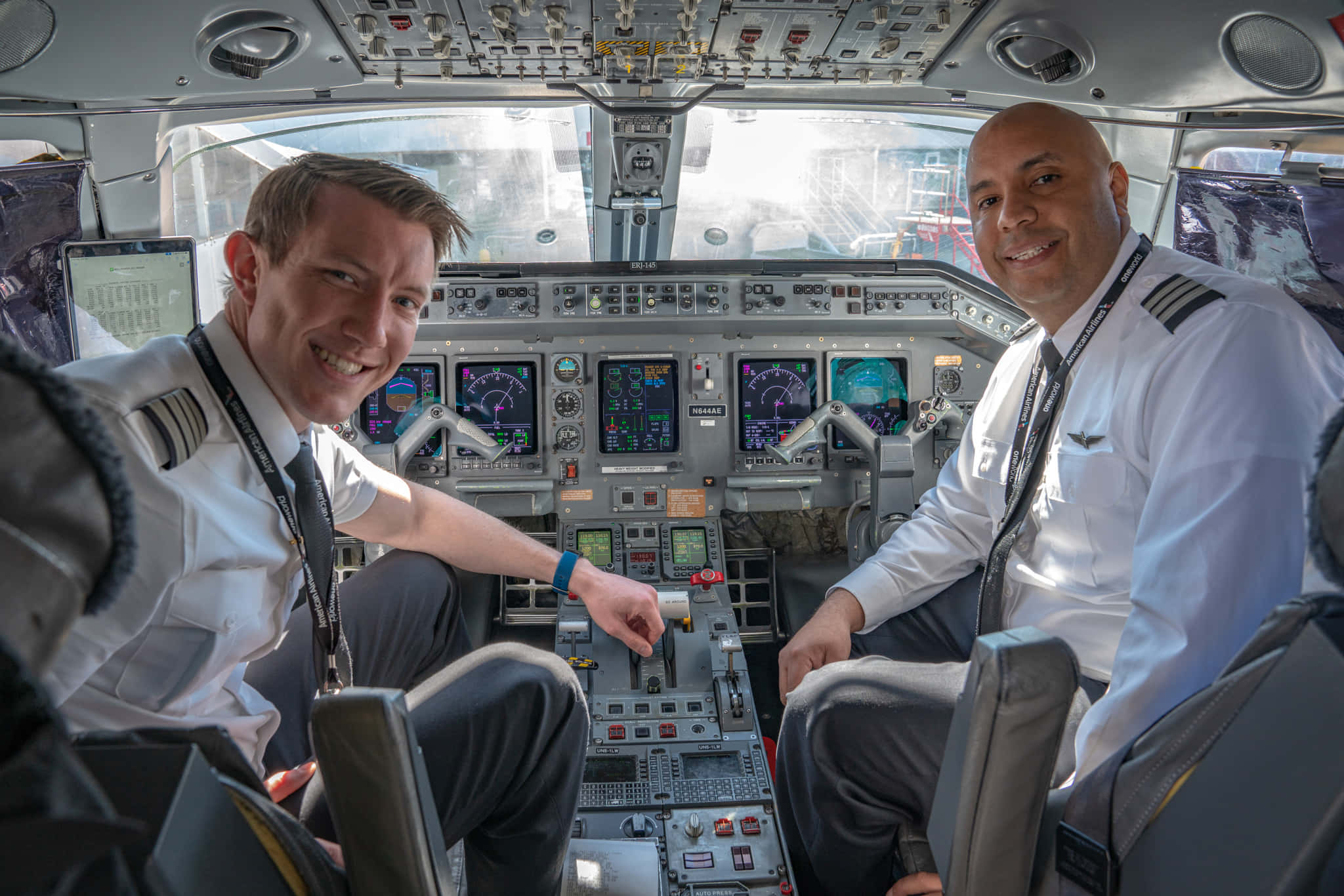 Two Smiling Pilot In Airplane Picture