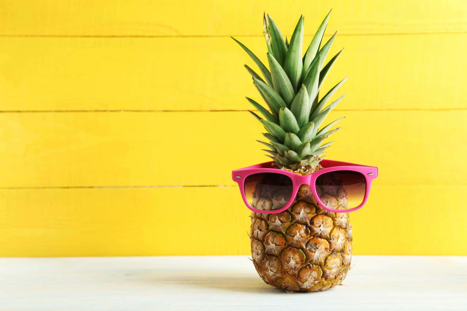 A Pineapple With Sunglasses On It On A Yellow Background Wallpaper