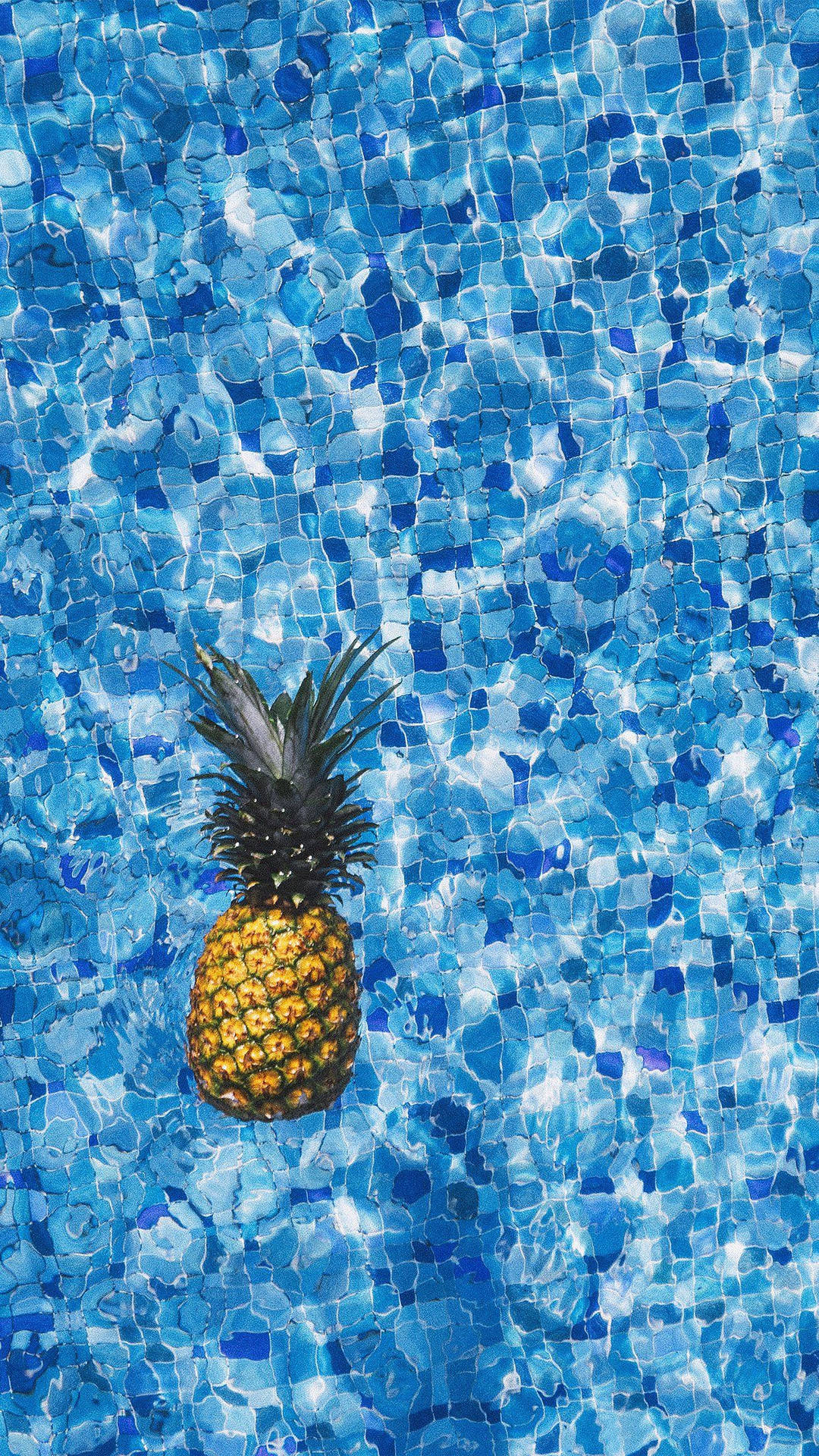 A Pineapple Floating In A Pool Wallpaper