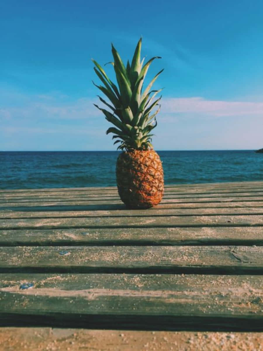 Pineapple On Wooden Deck By The Sea