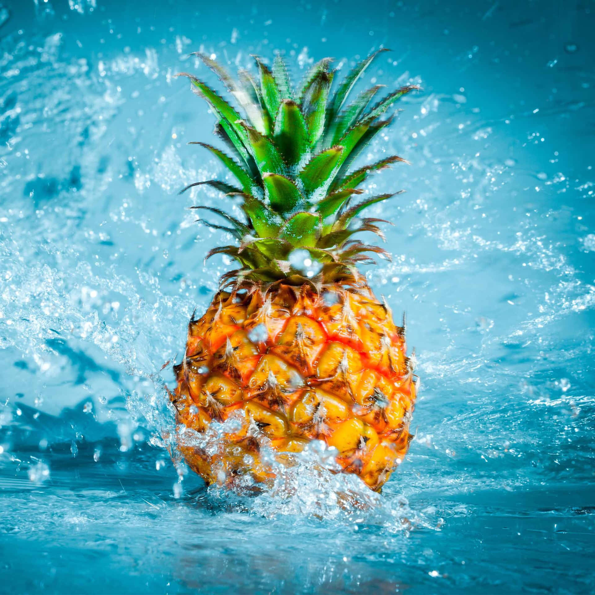Pineapple Splashing In Water On Blue Background