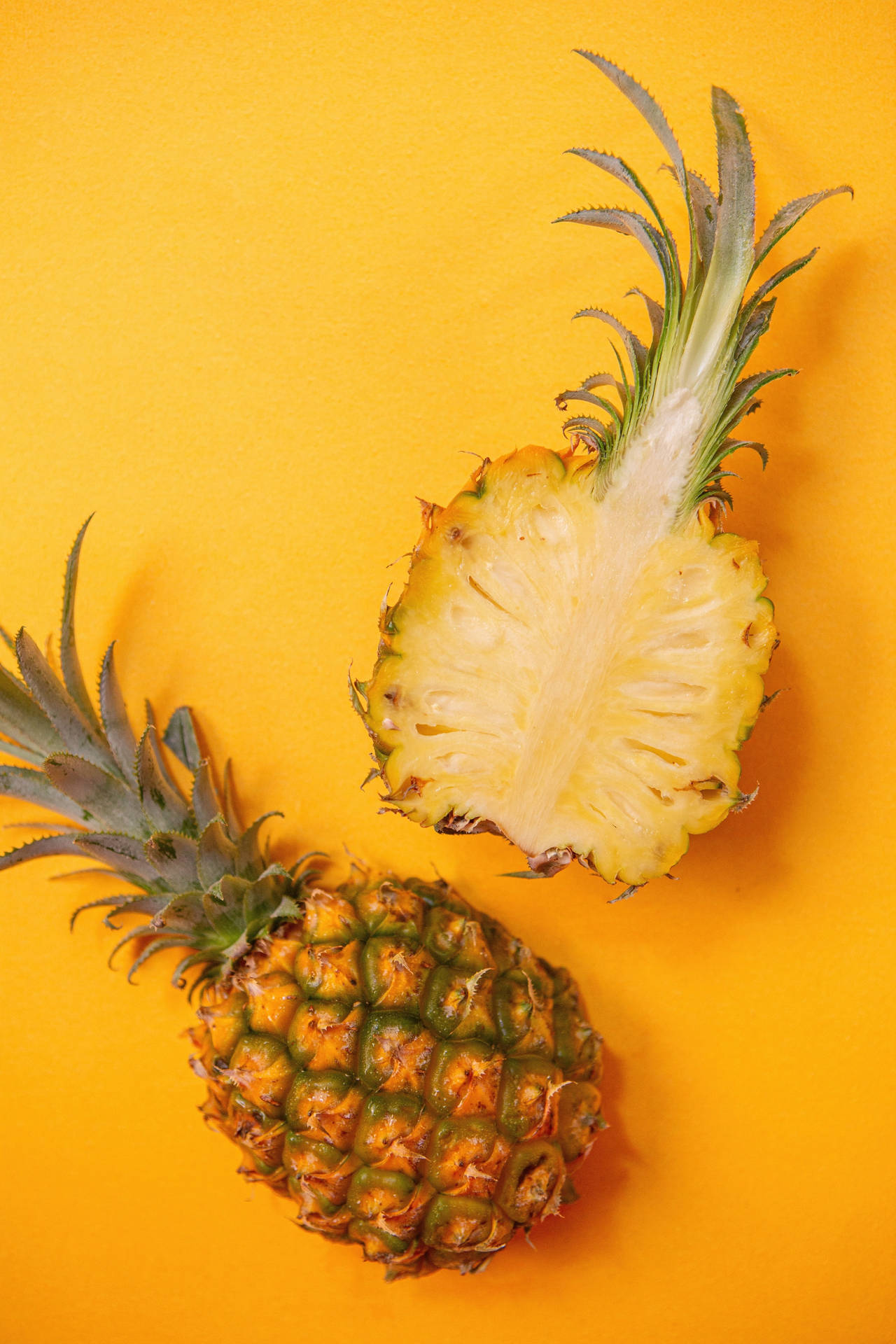 Vibrant iPhone Wallpaper Showcasing a Single Pineapple on a Yellow Background Wallpaper