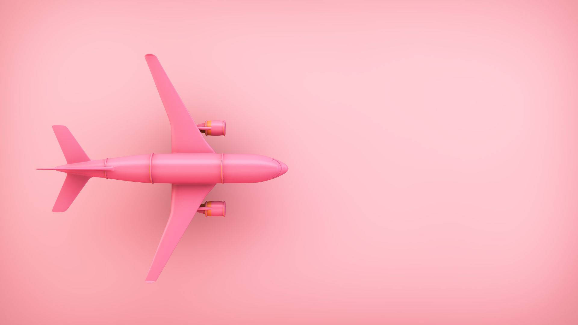 Vibrant Pink Toy Aeroplane Brightening Up the Sky Wallpaper