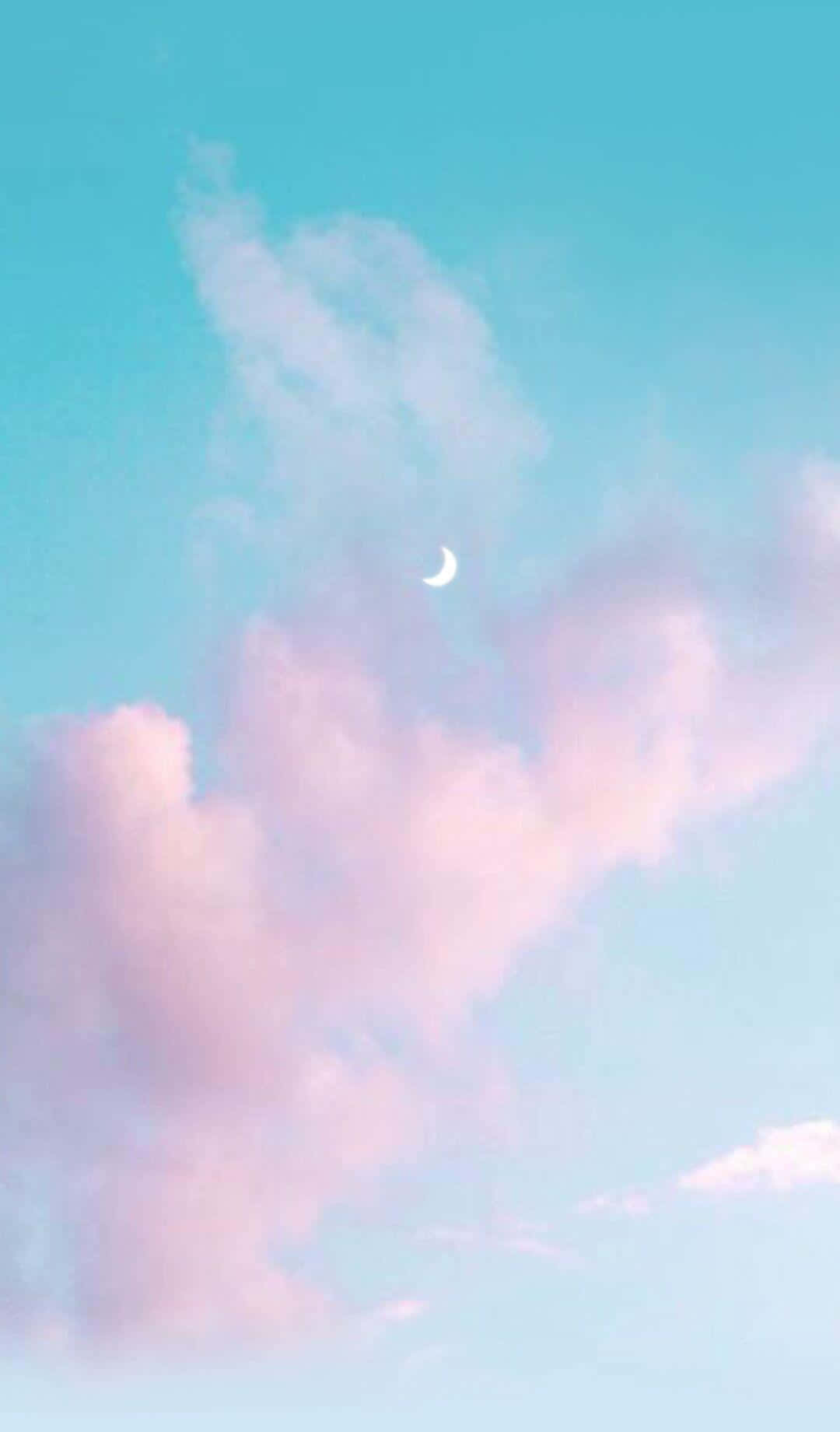 Uncielo Rosado Y Azul Con Nubes Y Una Media Luna