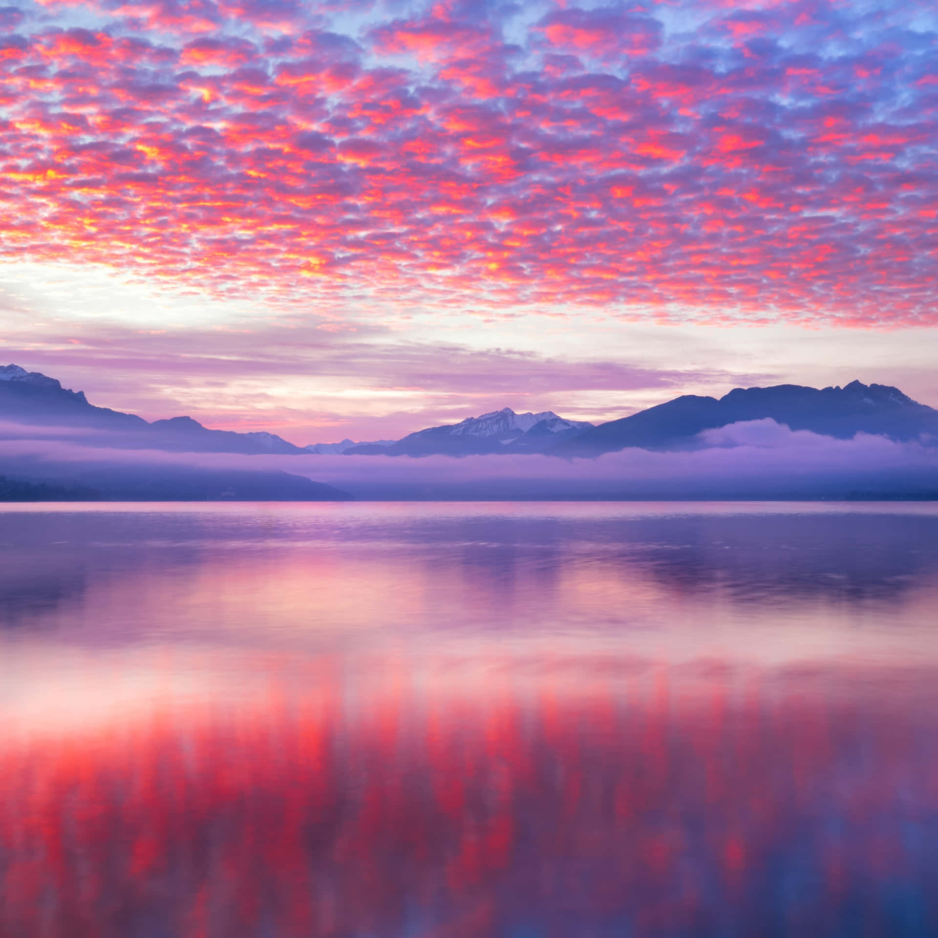 A Vibrant Sky Full of Pink and Blue Colored Clouds Wallpaper
