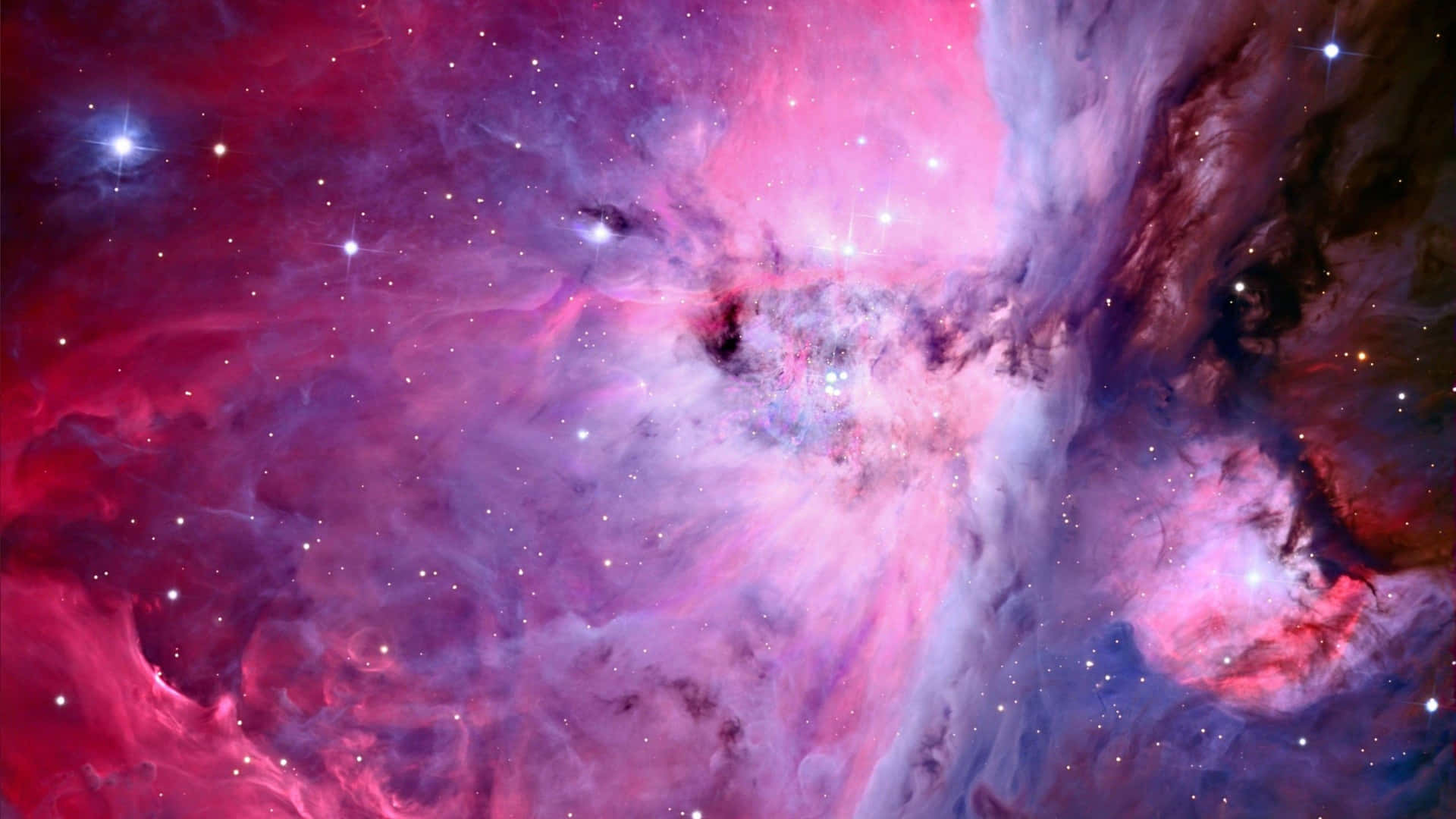 A stunning spiral galaxy in a bright pink and purple hue. Wallpaper