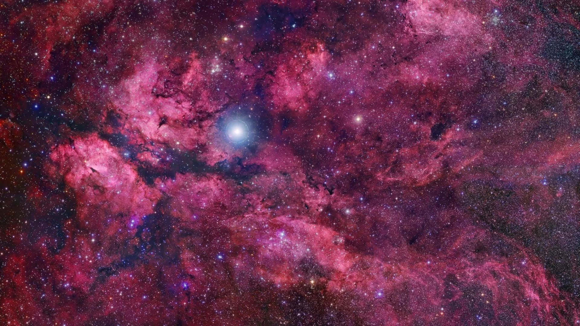 "Explore the Outer Reaches of the Universe with a Pink and Purple Galaxy" Wallpaper