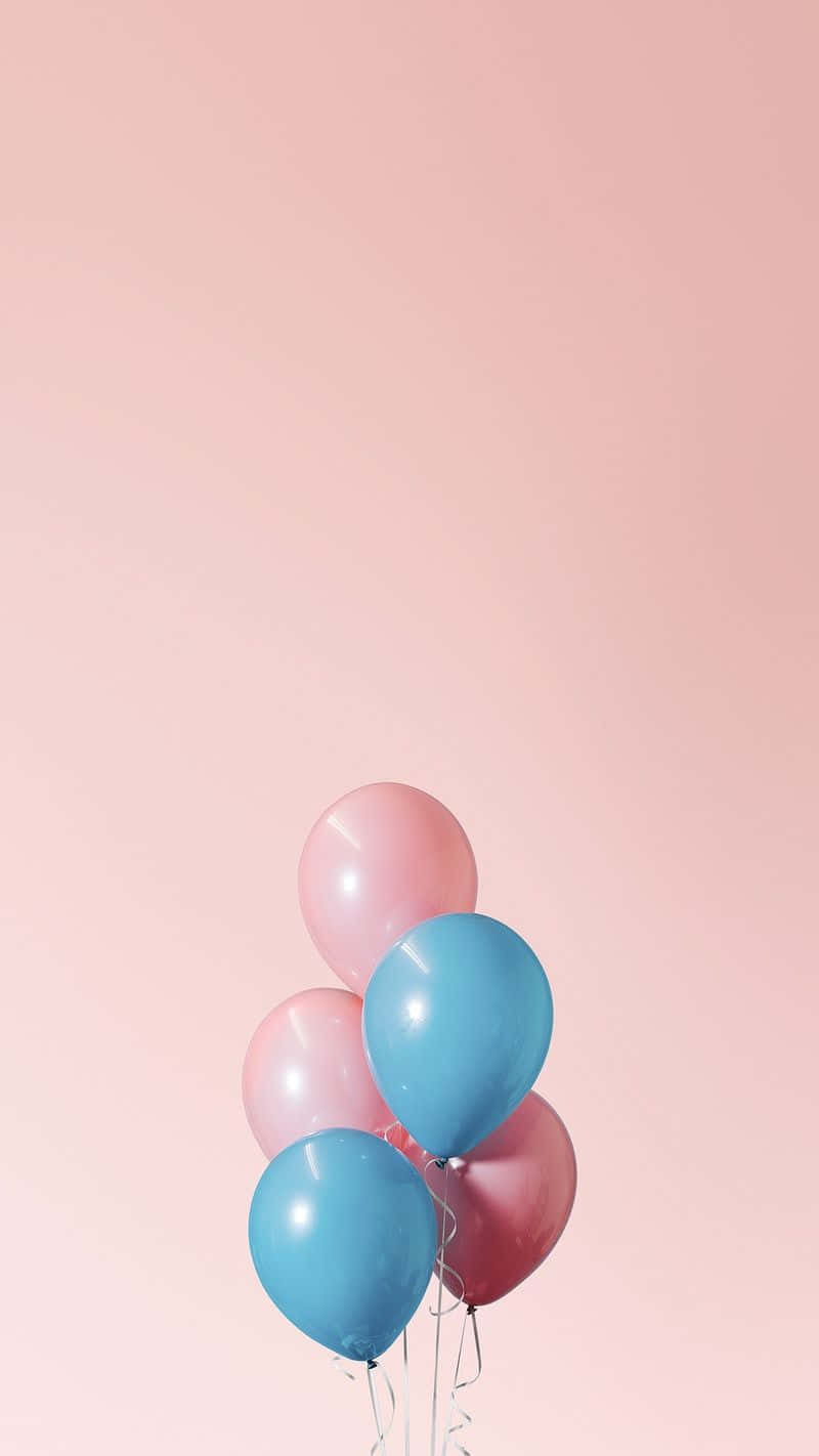 Pink And Blue Balloons On A Pink Background