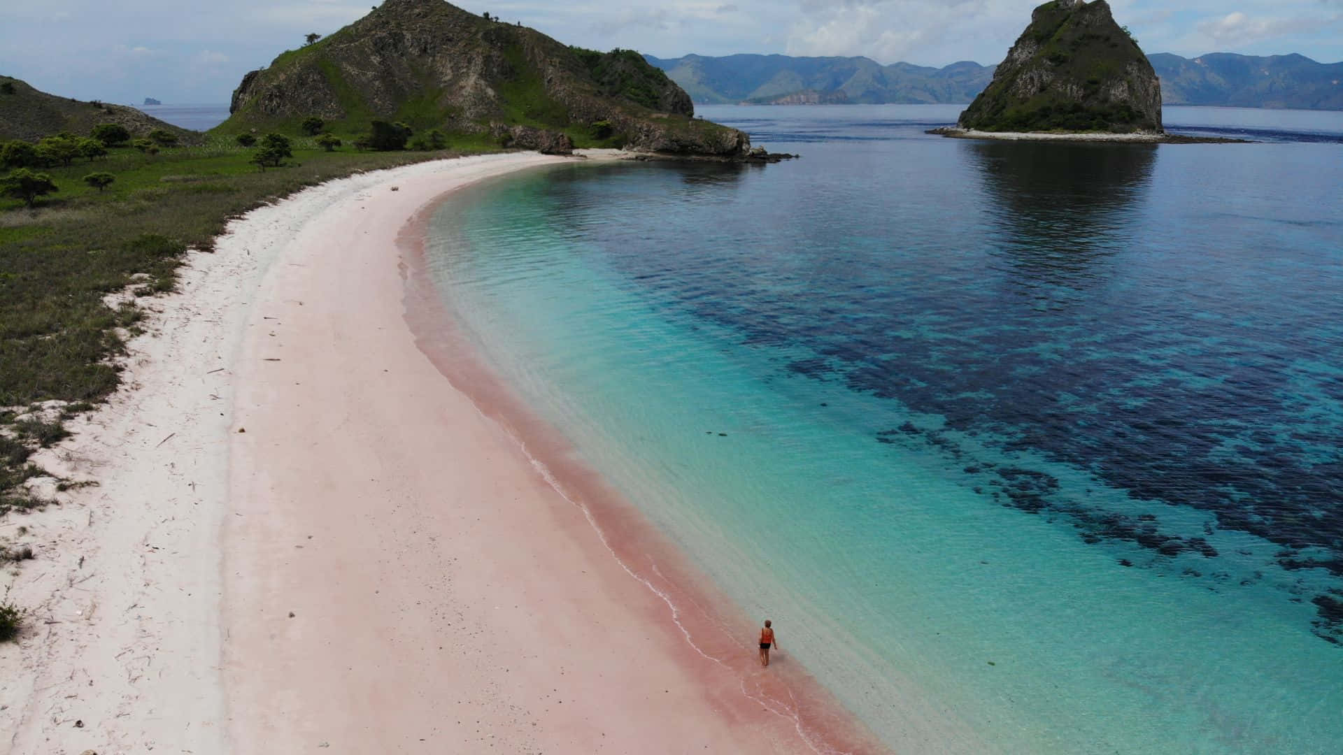 A breathtaking view of the serene Pink Beach Wallpaper