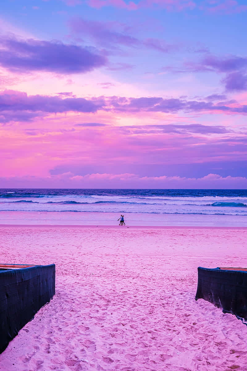 Slap af i roen ved en lyserød strand. Wallpaper